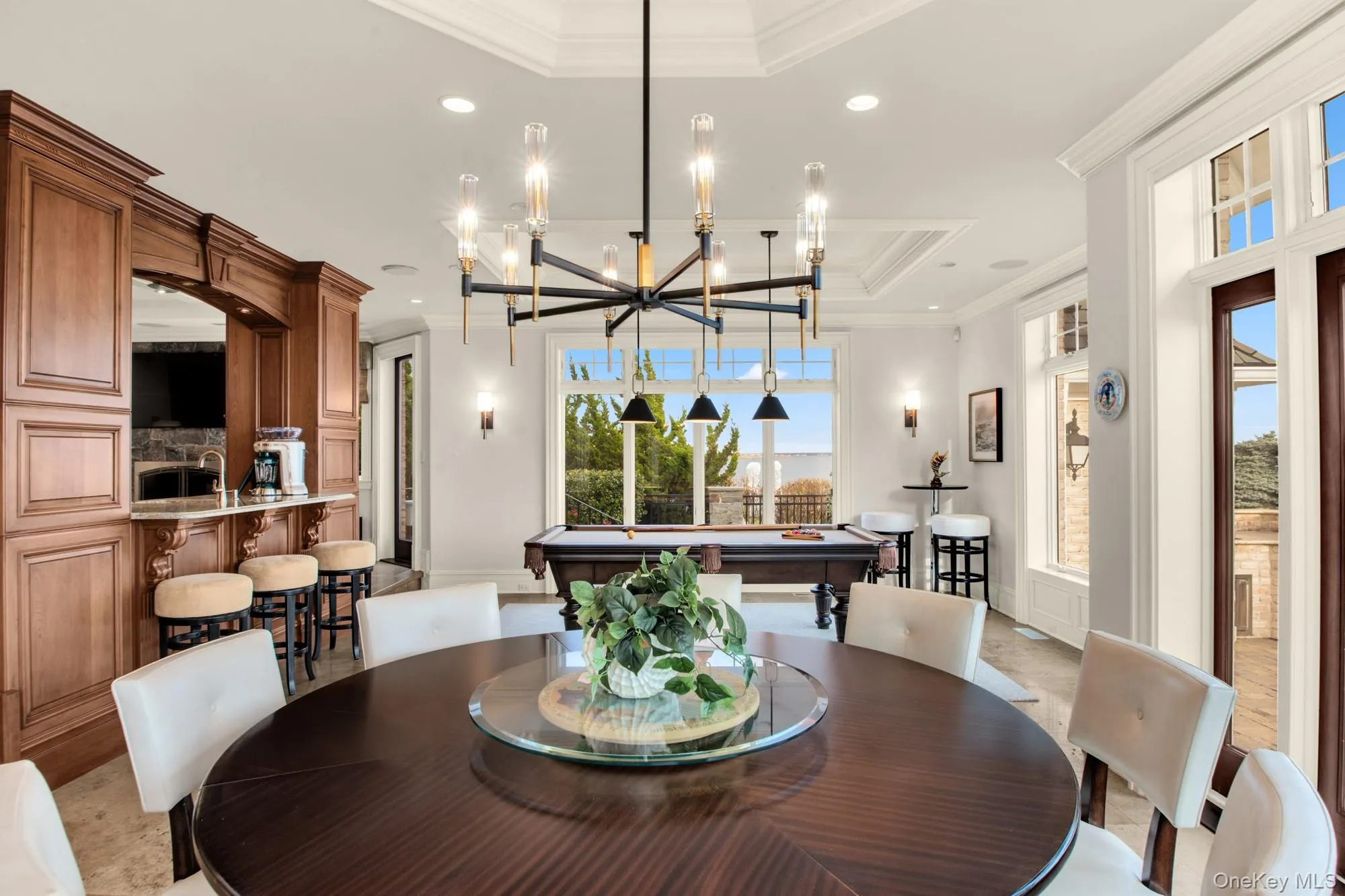 Dining space with a raised ceiling, ornamental molding, pool table, and recessed lighting Dining space with a raised ceiling, ornamental molding, pool table, and recessed lighting