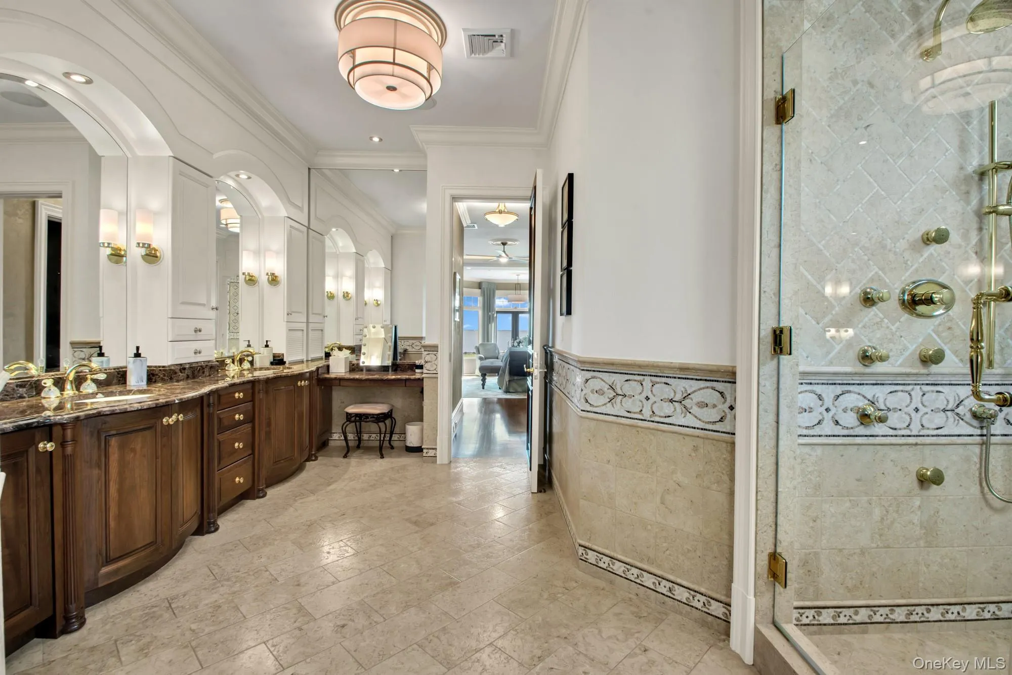 Full bathroom with vanity, a shower stall, crown molding, tile walls, and a wainscoted wall Full bathroom with vanity, a shower stall, crown molding, tile walls, and a wainscoted wall