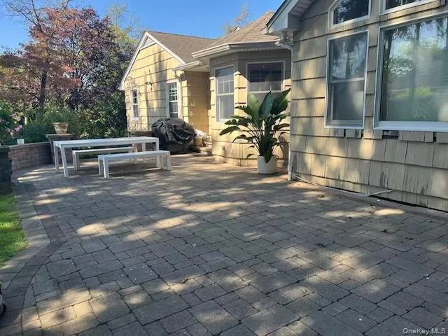 View of patio / terrace featuring grilling area and outdoor dining area View of patio / terrace featuring grilling area and outdoor dining area