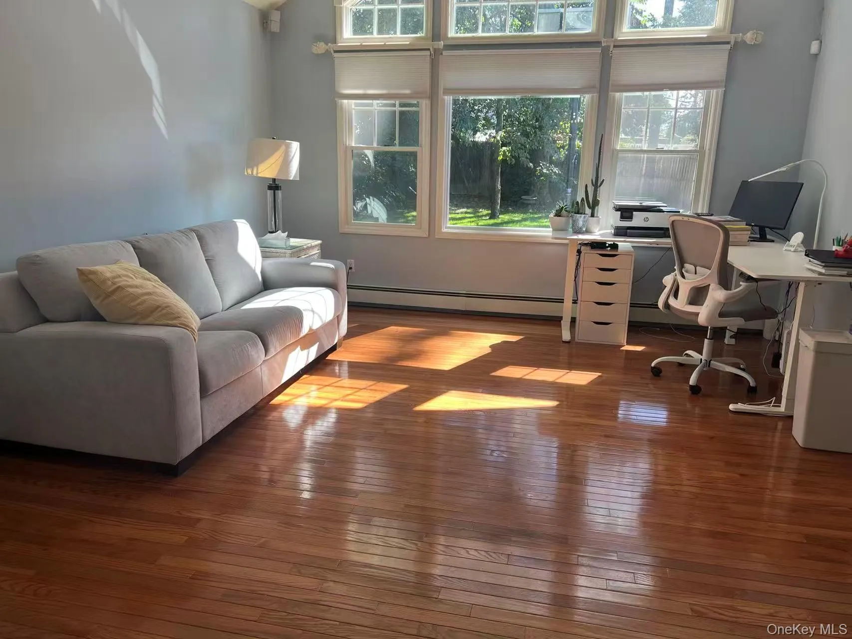 Office area with dark wood finished floors and baseboard heating Office area with dark wood finished floors and baseboard heating