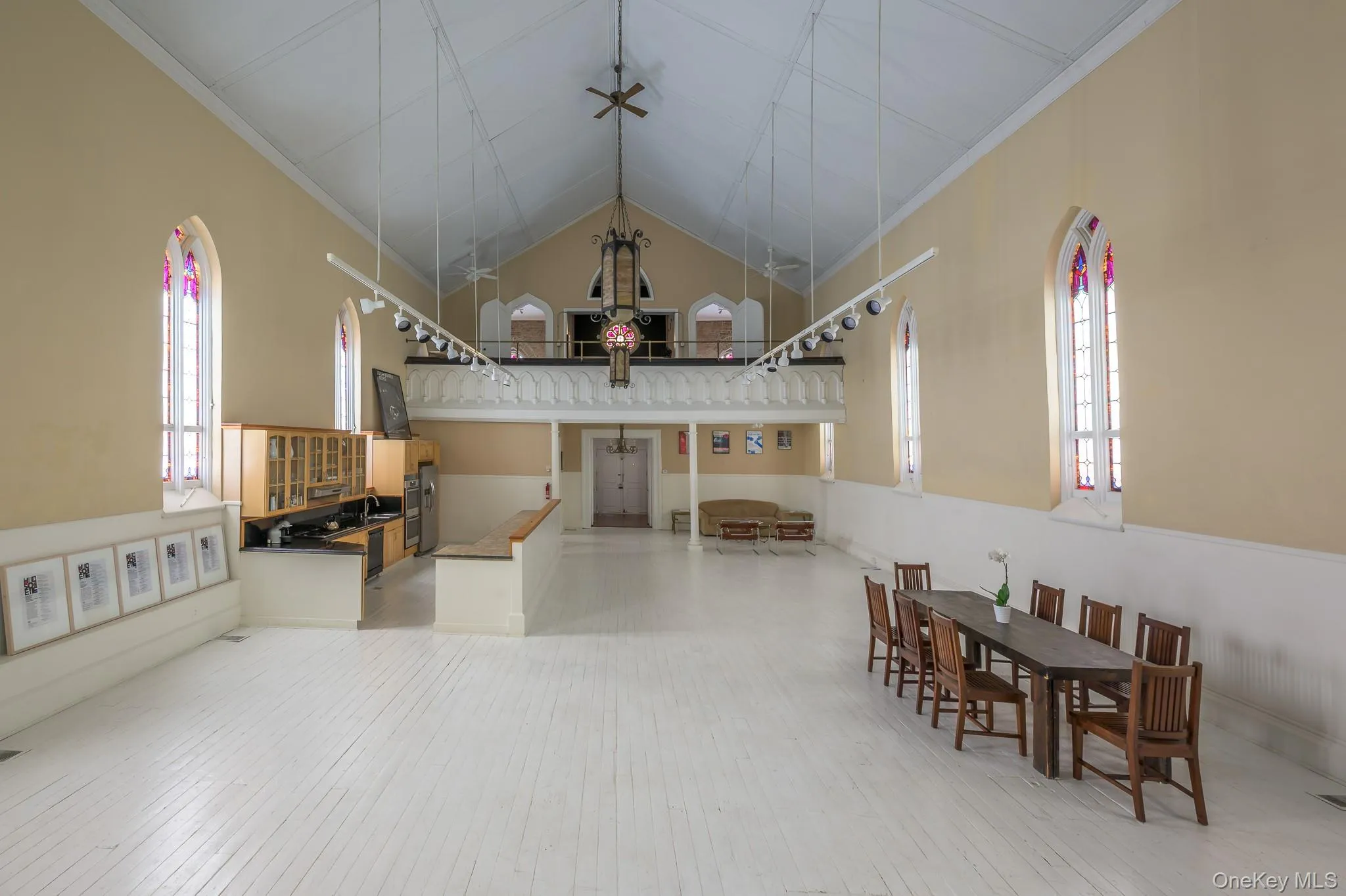 Dining area with crown molding, high vaulted ceiling, and light wood finished floors Dining area with crown molding, high vaulted ceiling, and light wood finished floors