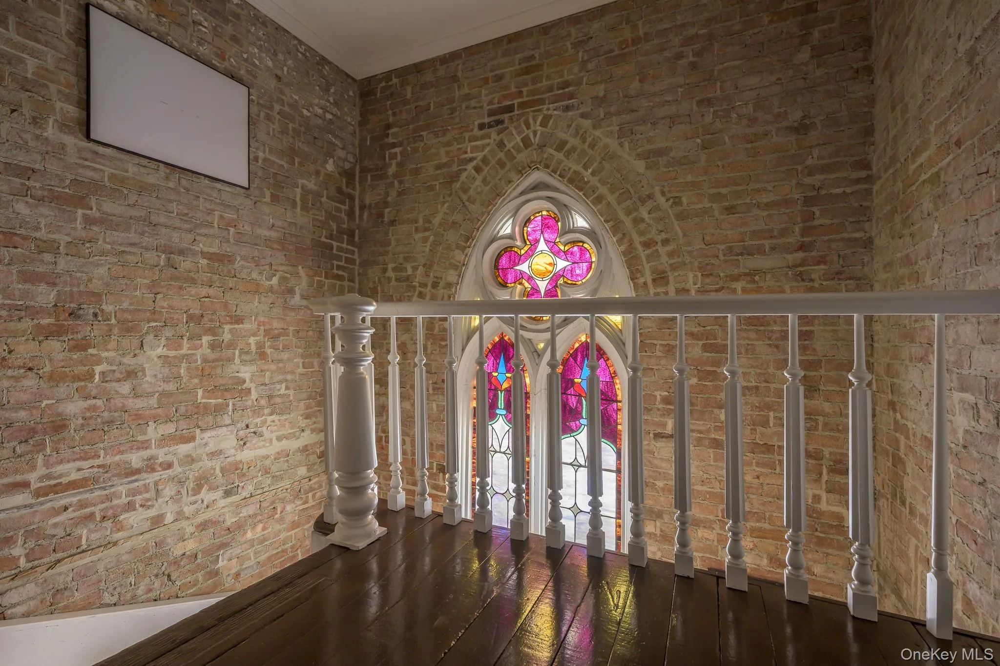 Detailed view of brick wall, wood finished floors, and ornamental molding Detailed view of brick wall, wood finished floors, and ornamental molding