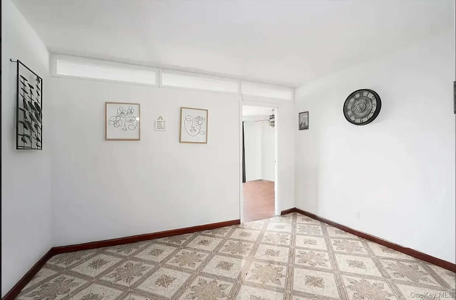 Unfurnished room with baseboards and light flooring Unfurnished room with baseboards and light flooring