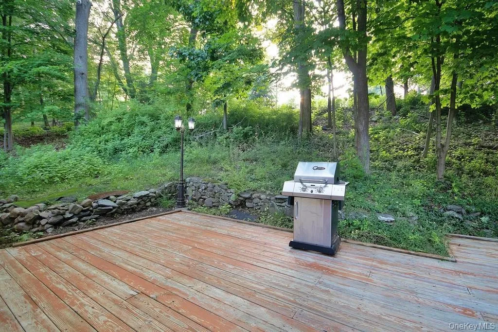 Wooden terrace featuring grilling area Wooden terrace featuring grilling area