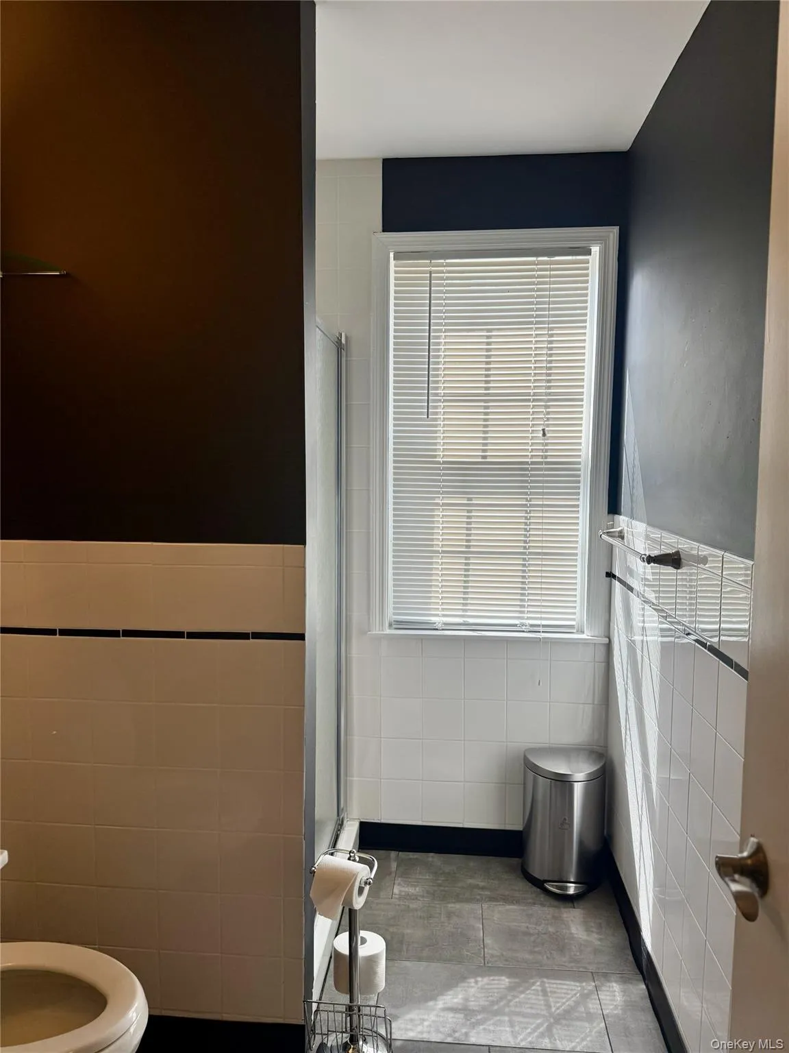 Full bath with tile walls and a shower stall Full bath with tile walls and a shower stall