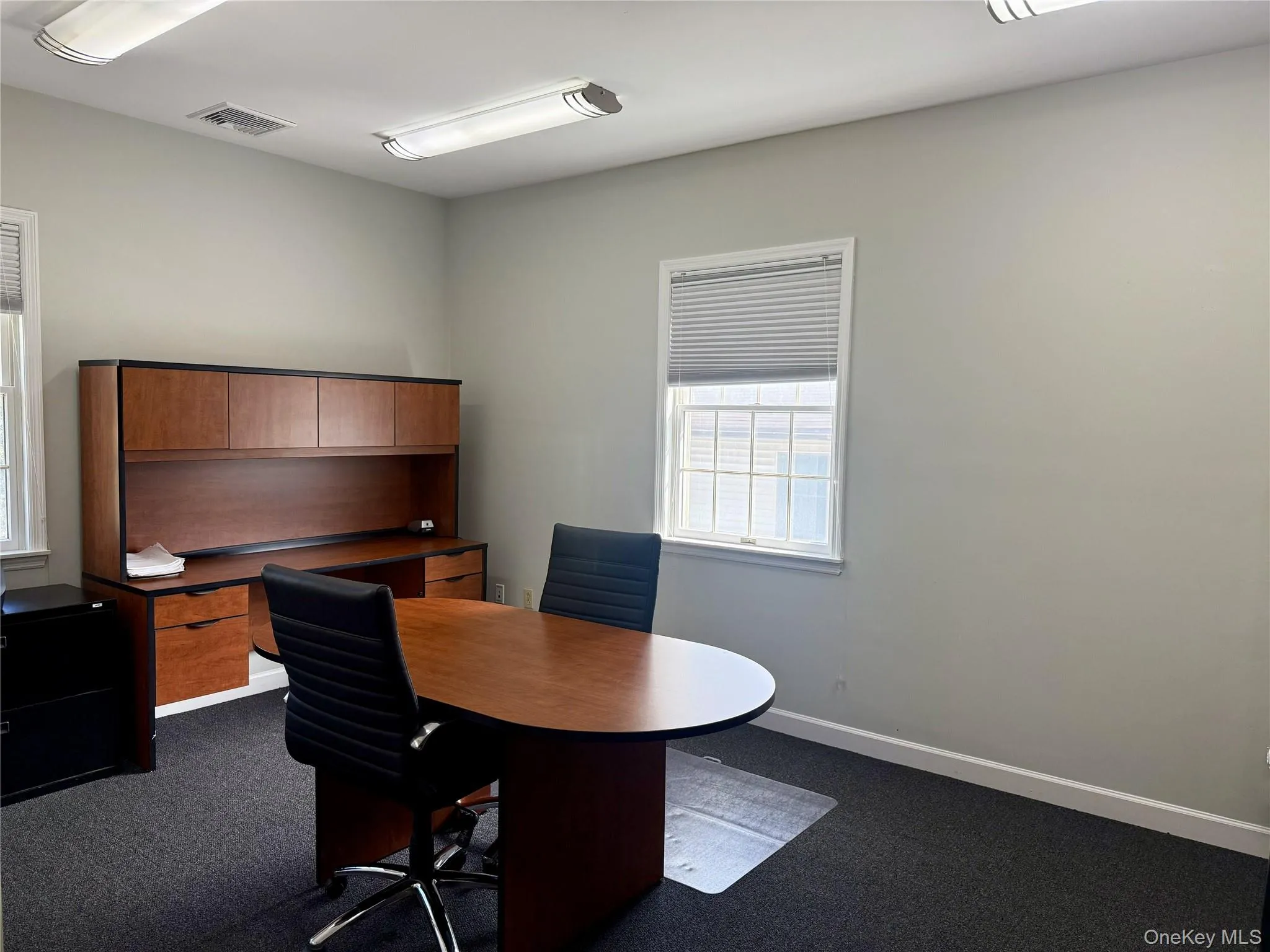 Office featuring dark colored carpet and baseboards Office featuring dark colored carpet and baseboards