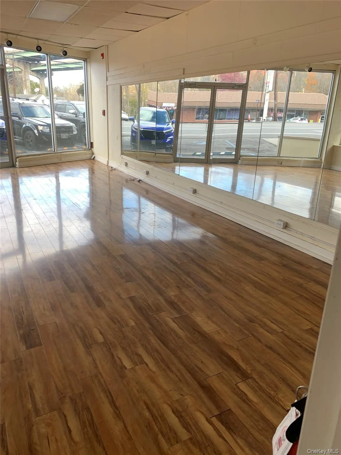 Unfurnished room with wood finished floors and plenty of natural light Unfurnished room with wood finished floors and plenty of natural light