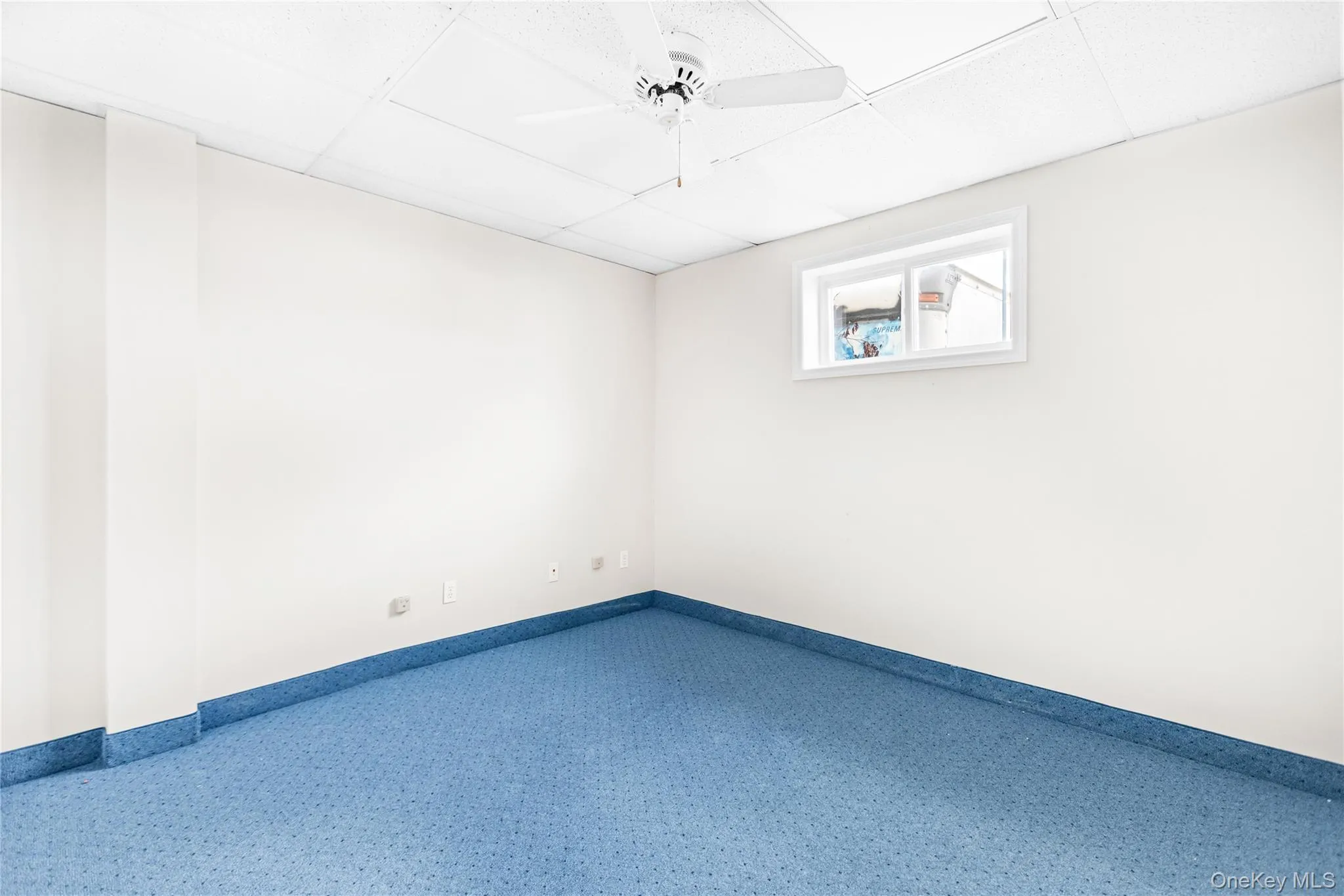 Office with a drop ceiling and ceiling fan Office with a drop ceiling and ceiling fan