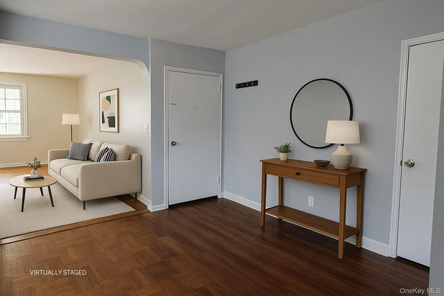 Living area featuring arched walkways and parquet flooring Living area featuring arched walkways and parquet flooring