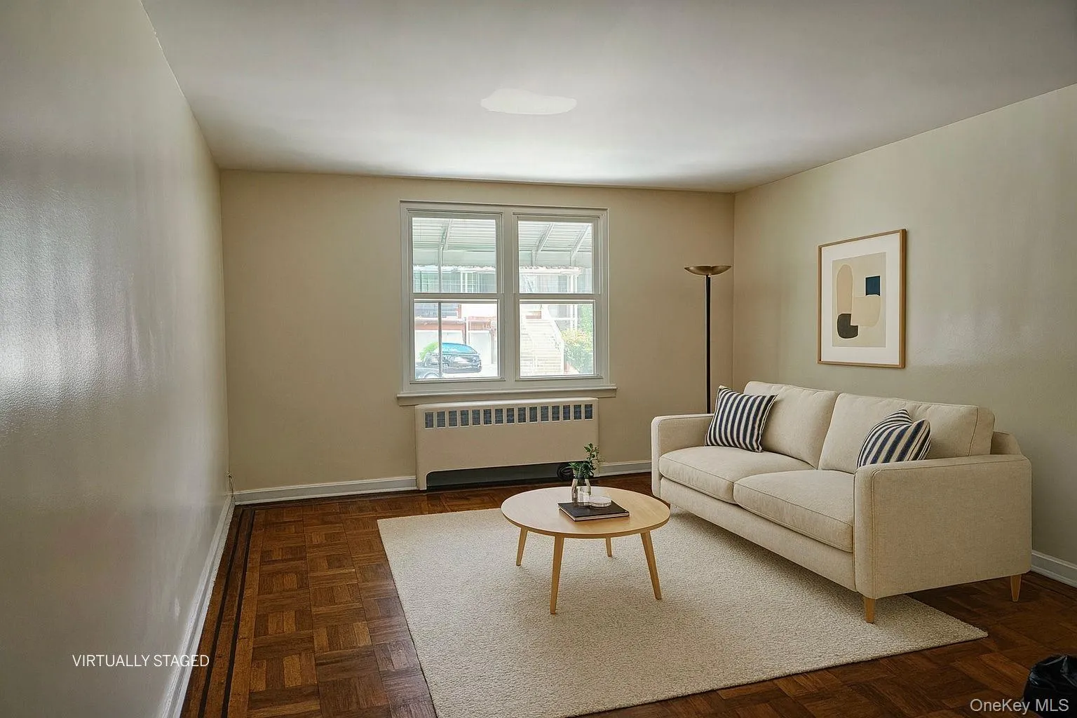 Living area featuring radiator and baseboards Living area featuring radiator and baseboards