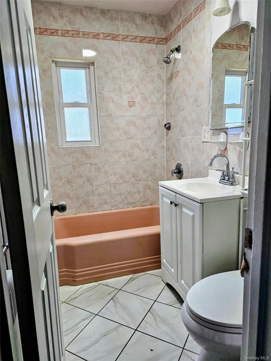 Full bath with shower / washtub combination, vanity, and tile walls Full bath with shower / washtub combination, vanity, and tile walls