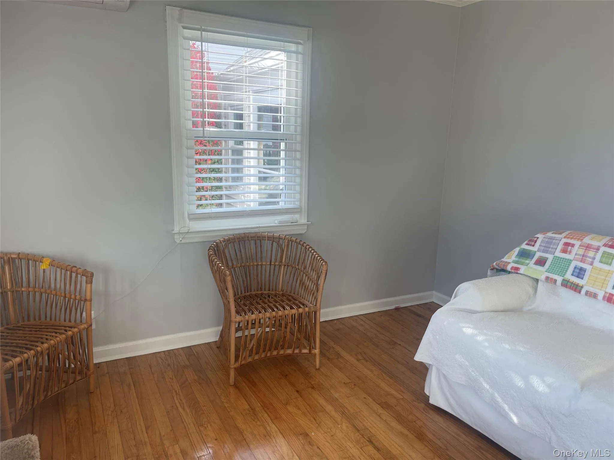 Sitting room featuring hardwood / wood-style flooring and baseboards Sitting room featuring hardwood / wood-style flooring and baseboards