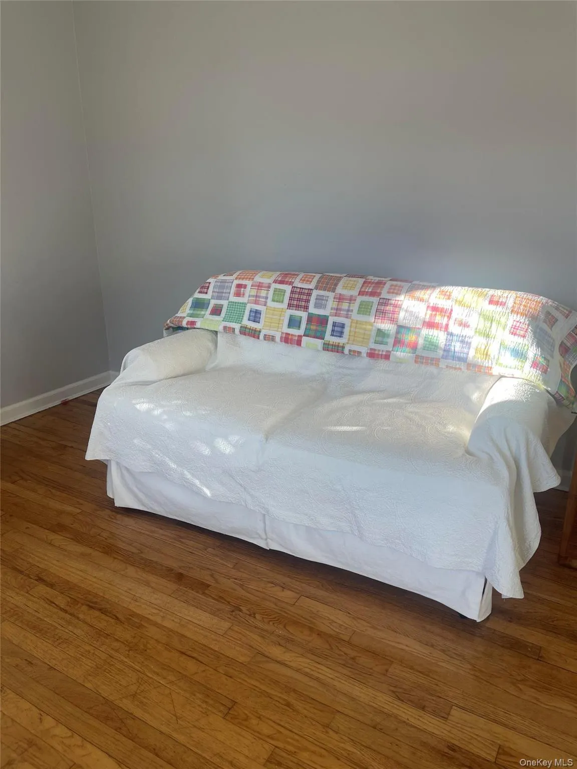 Bedroom with wood finished floors and baseboards Bedroom with wood finished floors and baseboards