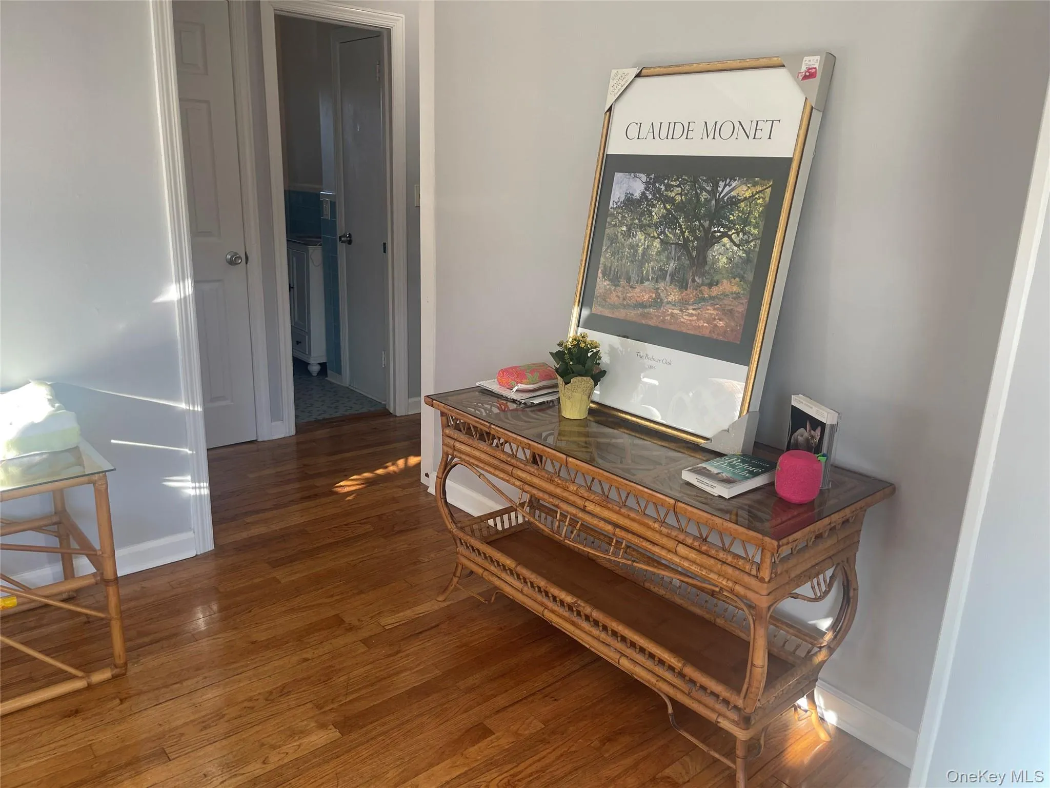 Hall with dark wood-style floors and baseboards Hall with dark wood-style floors and baseboards