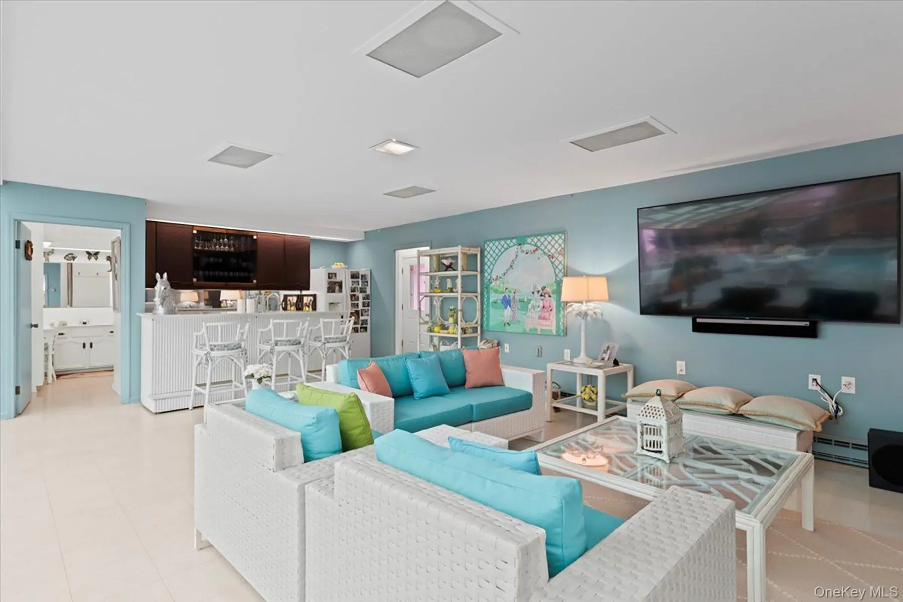 Living area featuring a baseboard heating unit and bar Living area featuring a baseboard heating unit and bar