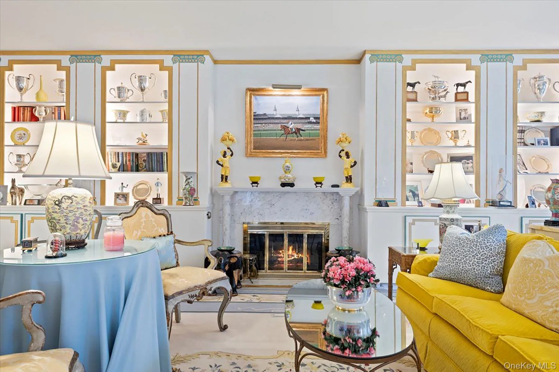 Living area featuring a high end fireplace and ornamental molding Living area featuring a high end fireplace and ornamental molding