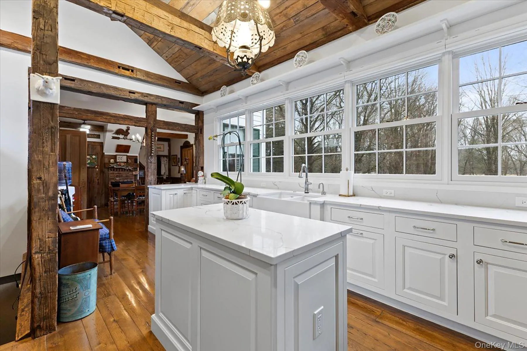 Kitchen featuring white cabinetry, dark wood-style flooring, a wooden ceiling with exposed beams, high vaulted ceiling, and a center island Kitchen featuring white cabinetry, dark wood-style flooring, a wooden ceiling with exposed beams, high vaulted ceiling, and a center island