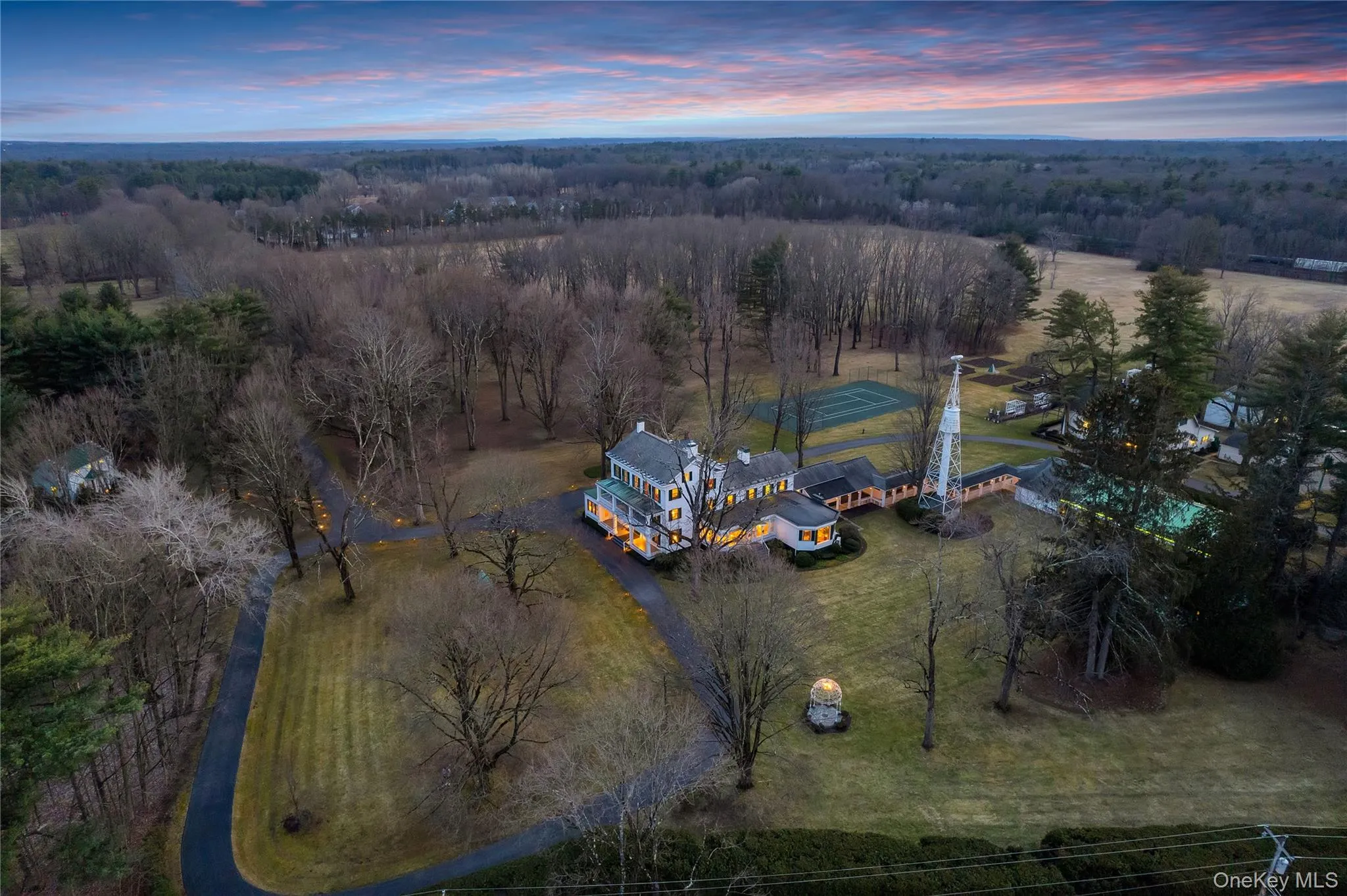 Aerial view of property and surrounding area with a forest Aerial view of property and surrounding area with a forest