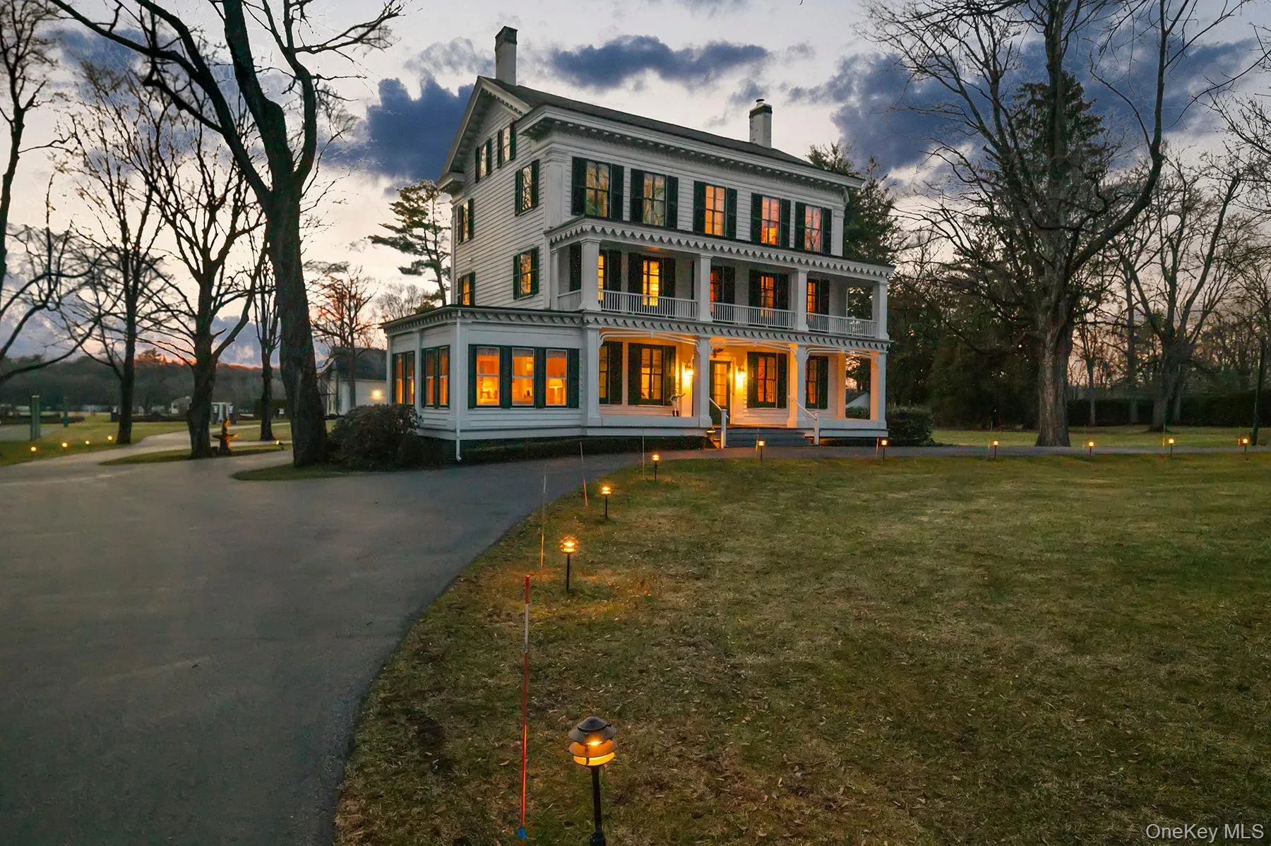 Italianate house with a chimney, a large porch, and a yard Italianate house with a chimney, a large porch, and a yard