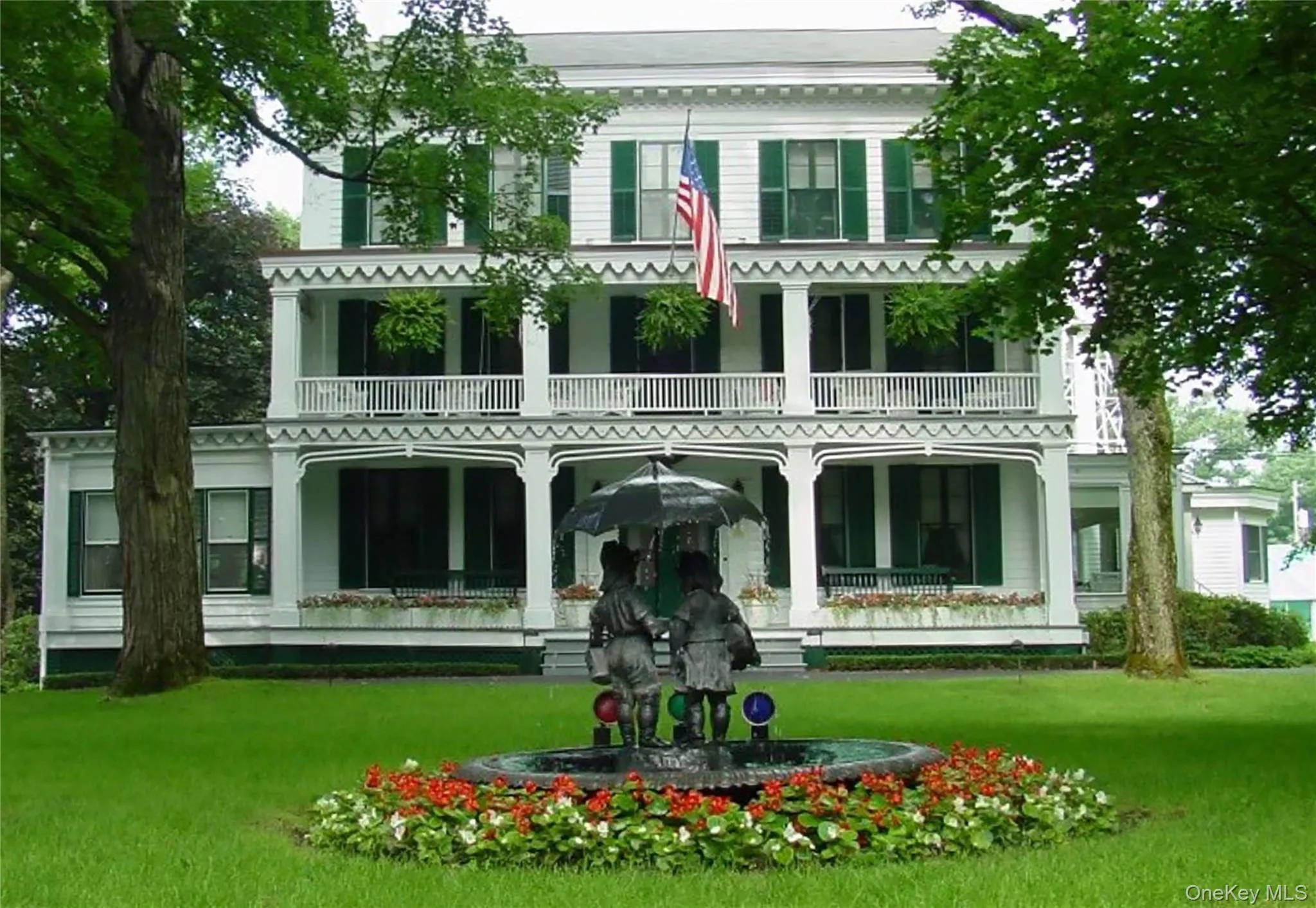 property featuring covered porch and a lawn property featuring covered porch and a lawn