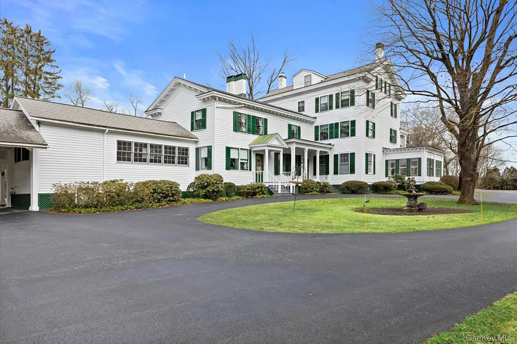 View of front of home with a chimney, driveway, and a front lawn View of front of home with a chimney, driveway, and a front lawn