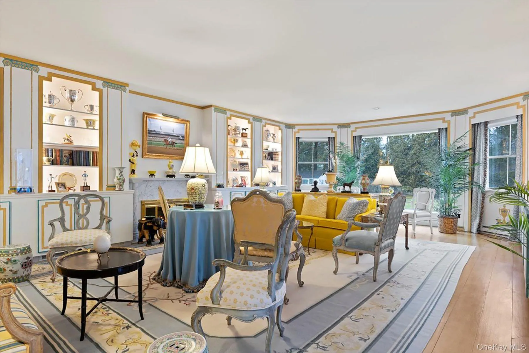 Living room with ornamental molding and wood-type flooring Living room with ornamental molding and wood-type flooring
