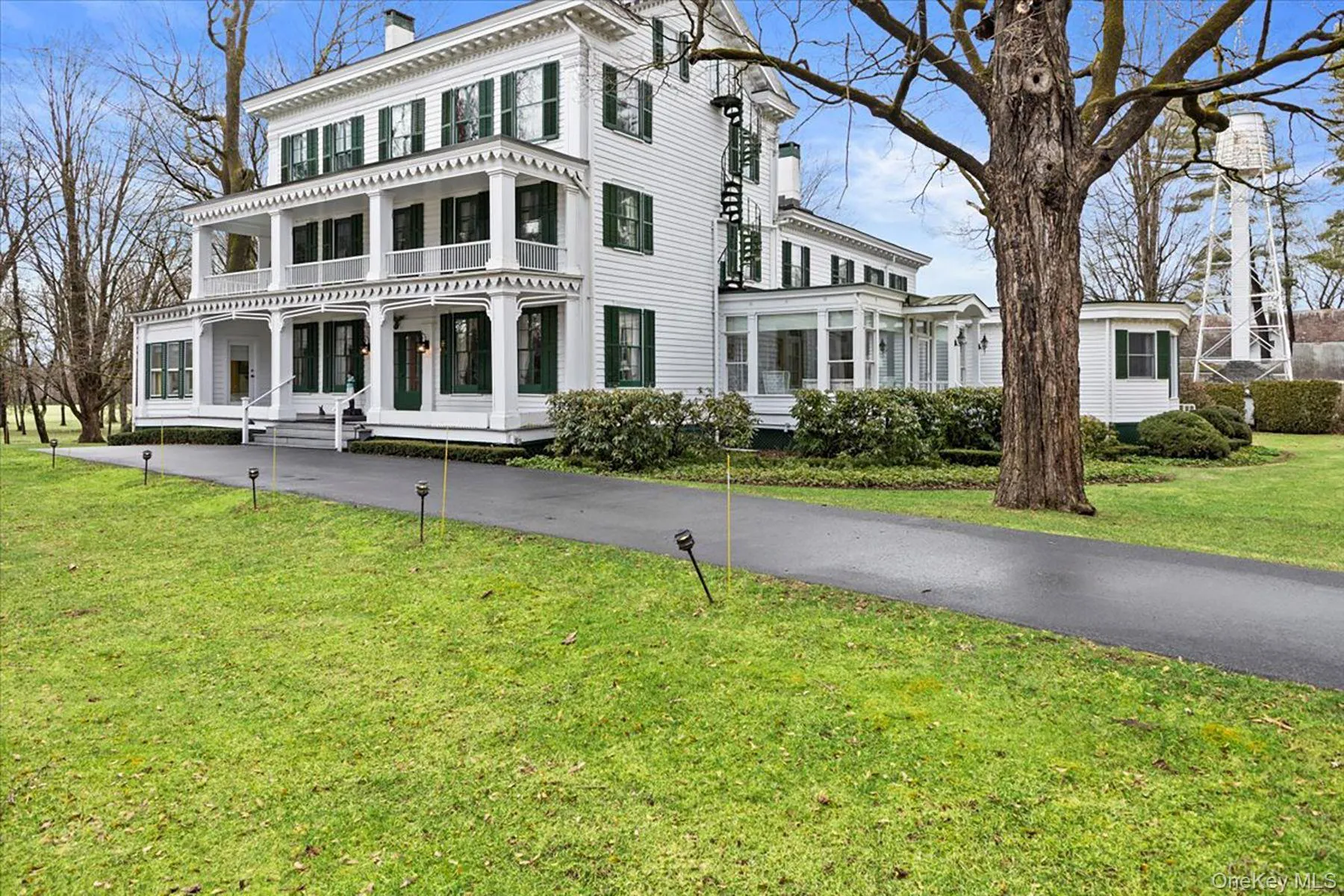 Italianate-style house featuring a chimney and a front yard Italianate-style house featuring a chimney and a front yard