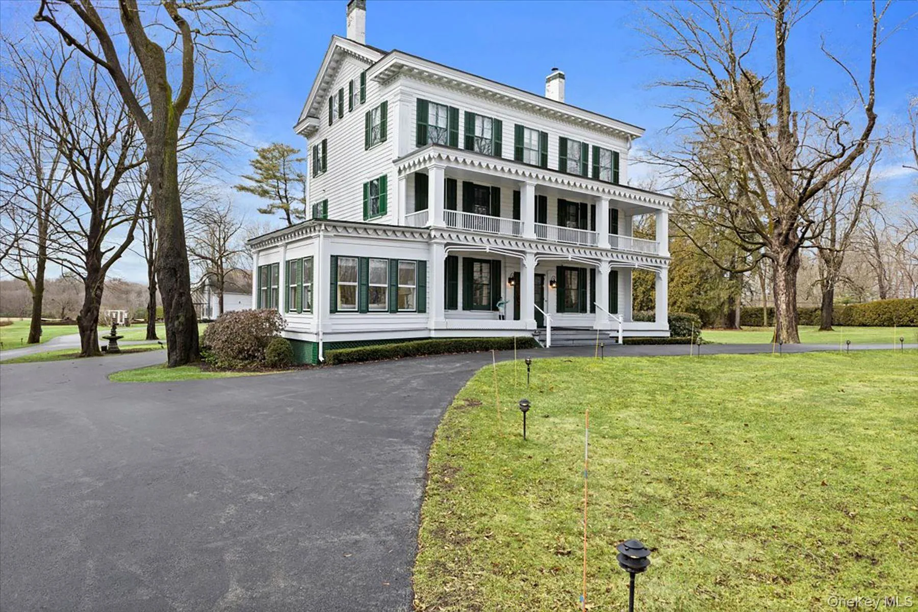 Italianate house with a chimney, a front yard, and a porch Italianate house with a chimney, a front yard, and a porch