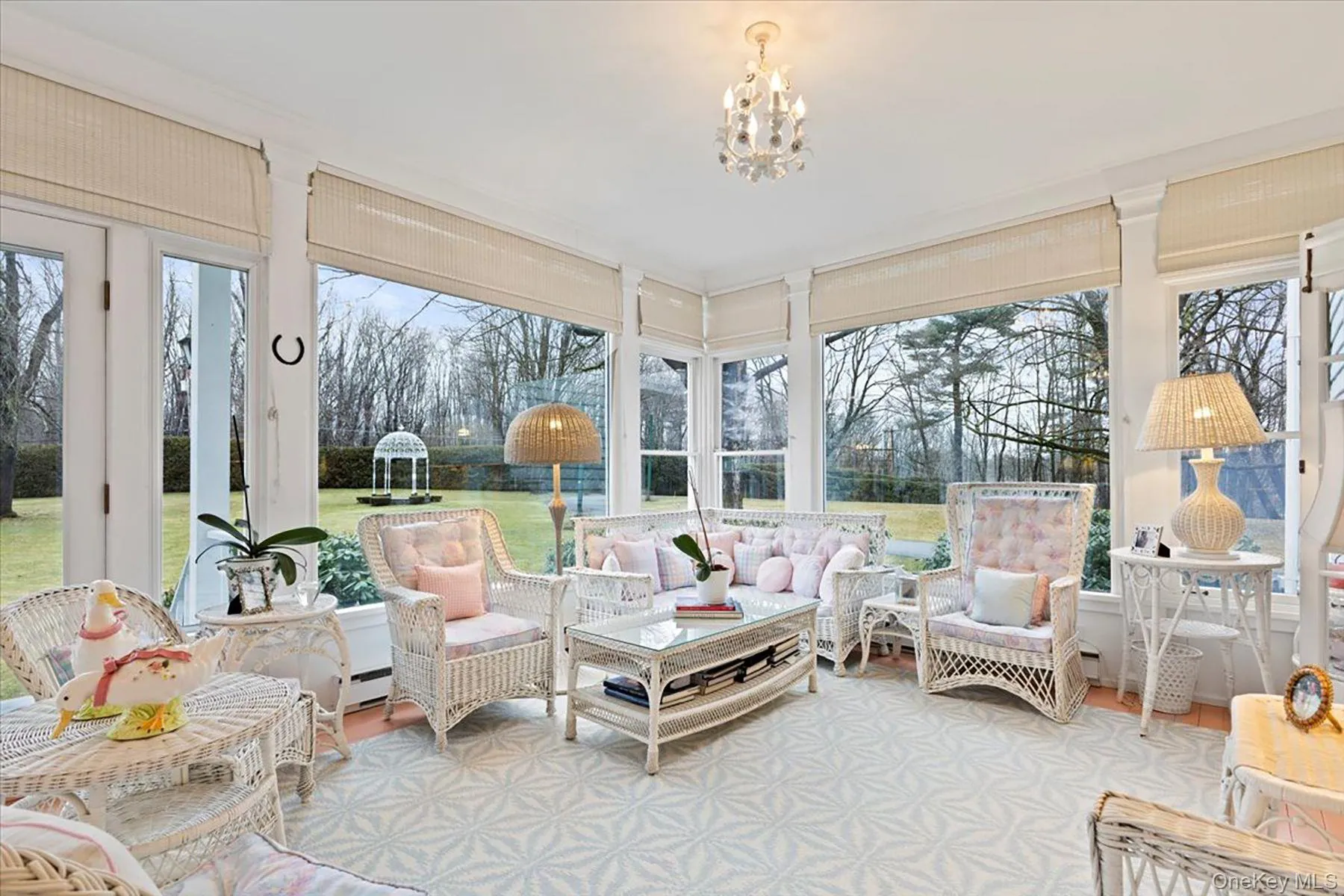 Sunroom with a chandelier, baseboard heating, and wood finished floors Sunroom with a chandelier, baseboard heating, and wood finished floors