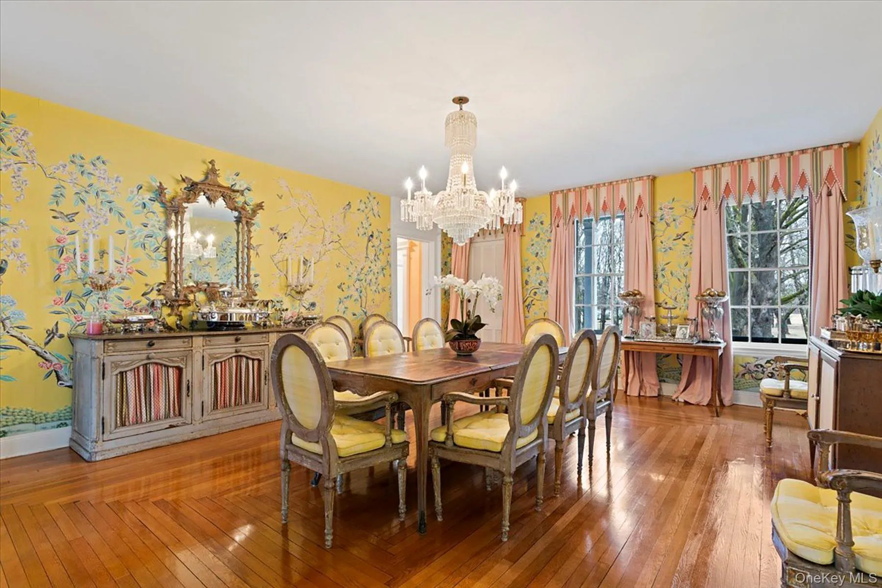 Dining space with wallpapered walls, hardwood / wood-style floors, and a chandelier Dining space with wallpapered walls, hardwood / wood-style floors, and a chandelier
