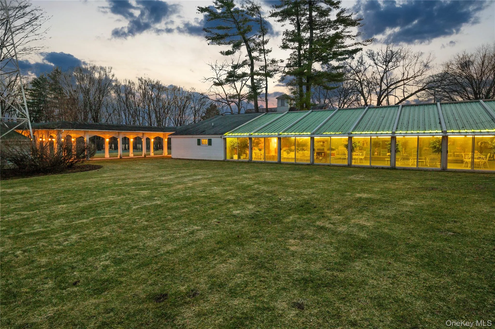 Back of property with a yard and a metal roof Back of property with a yard and a metal roof
