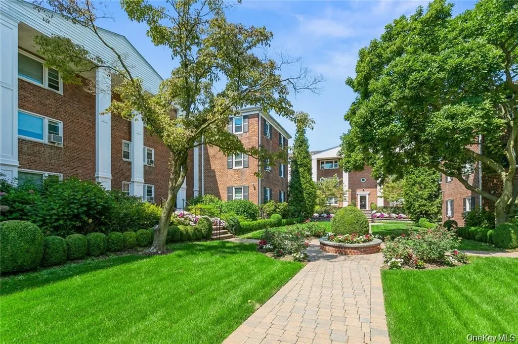 View of property's community with a yard View of property's community with a yard
