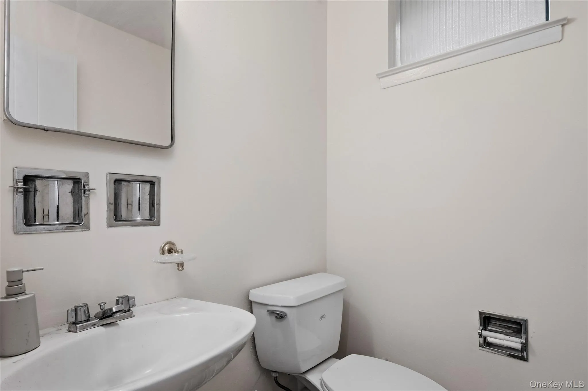 Bathroom featuring a sink and toilet Bathroom featuring a sink and toilet