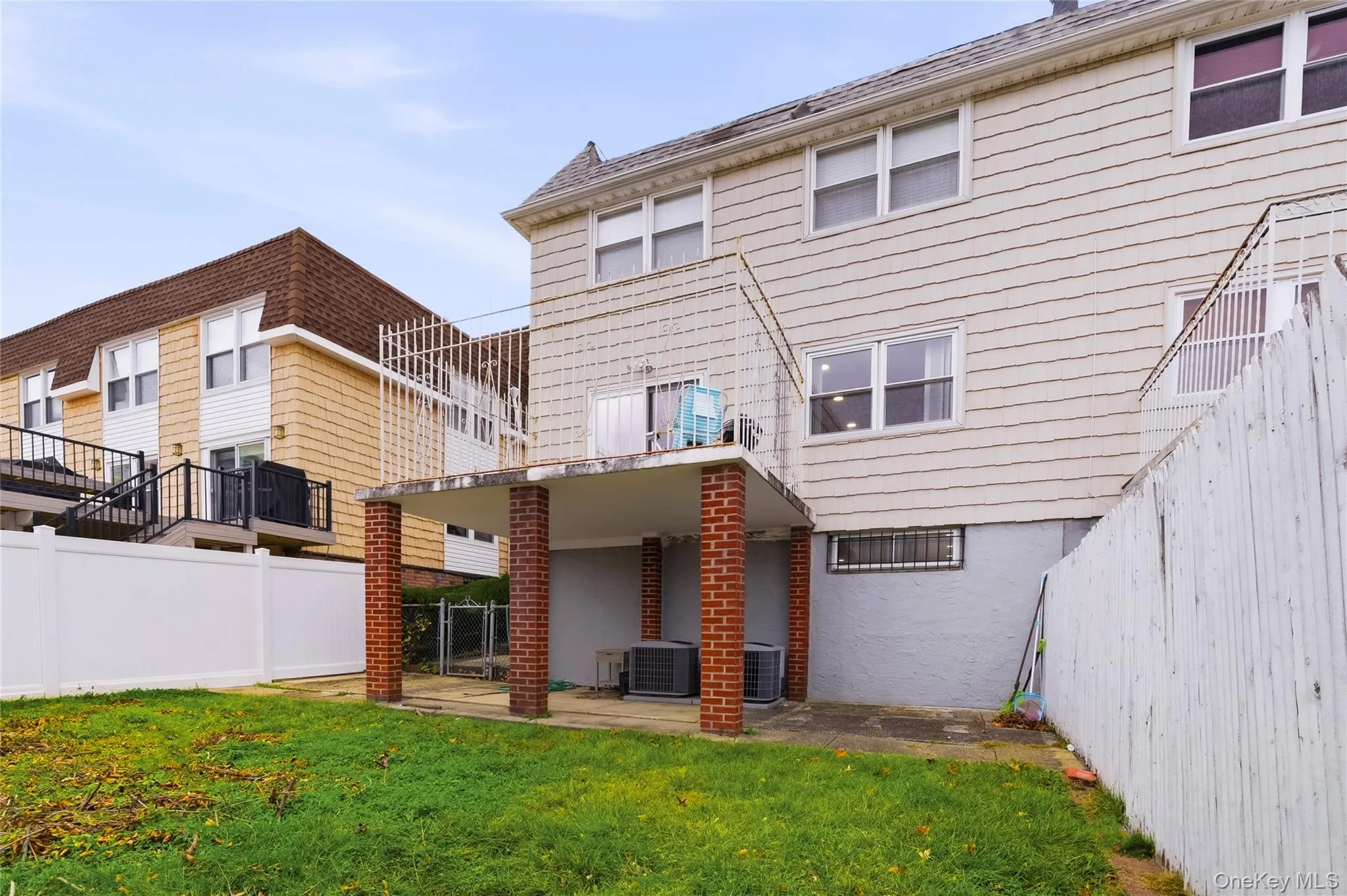 Back of property with a fenced backyard, a patio, and a balcony Back of property with a fenced backyard, a patio, and a balcony
