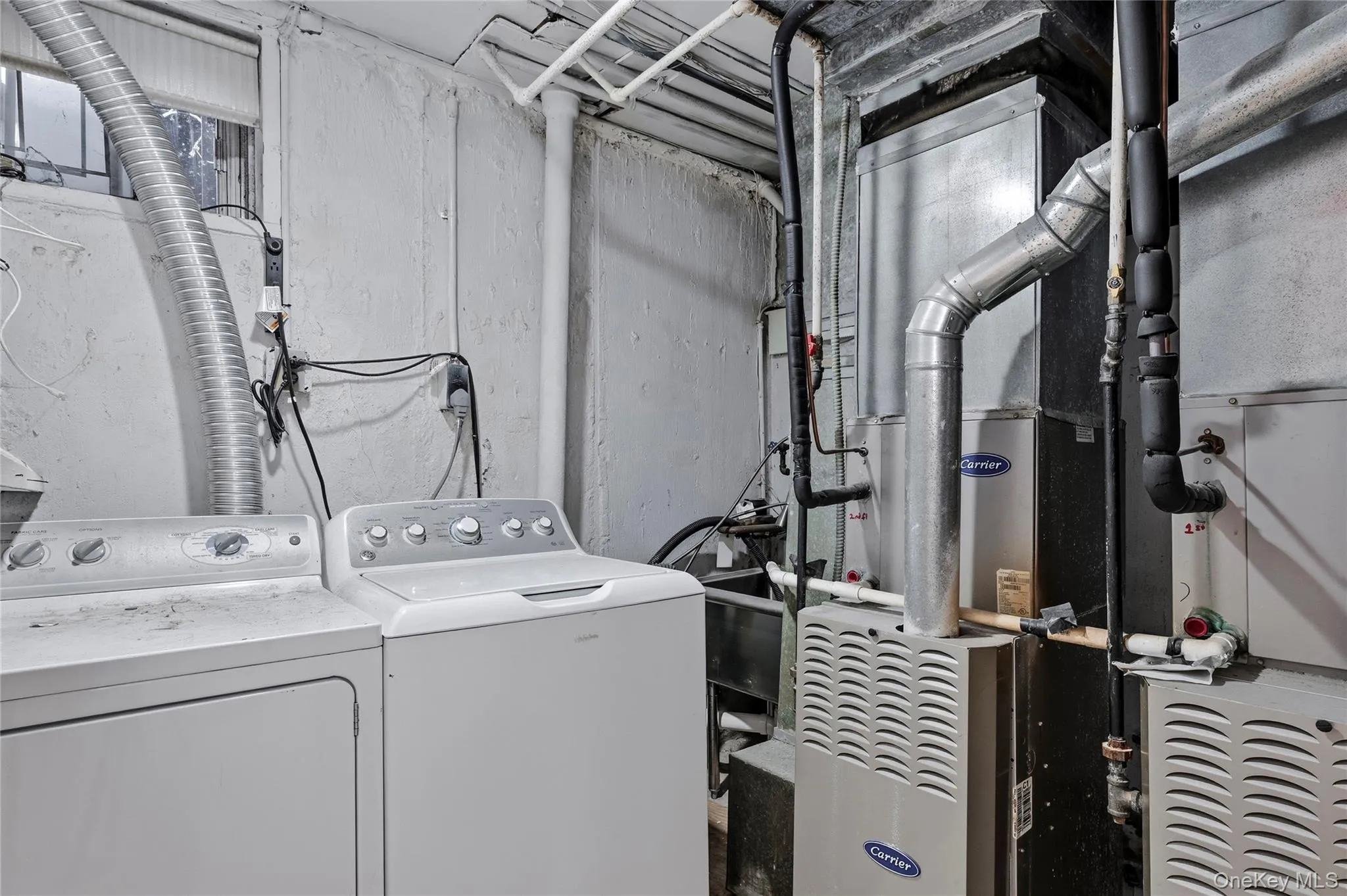 Washroom featuring heating unit and washing machine and clothes dryer Washroom featuring heating unit and washing machine and clothes dryer