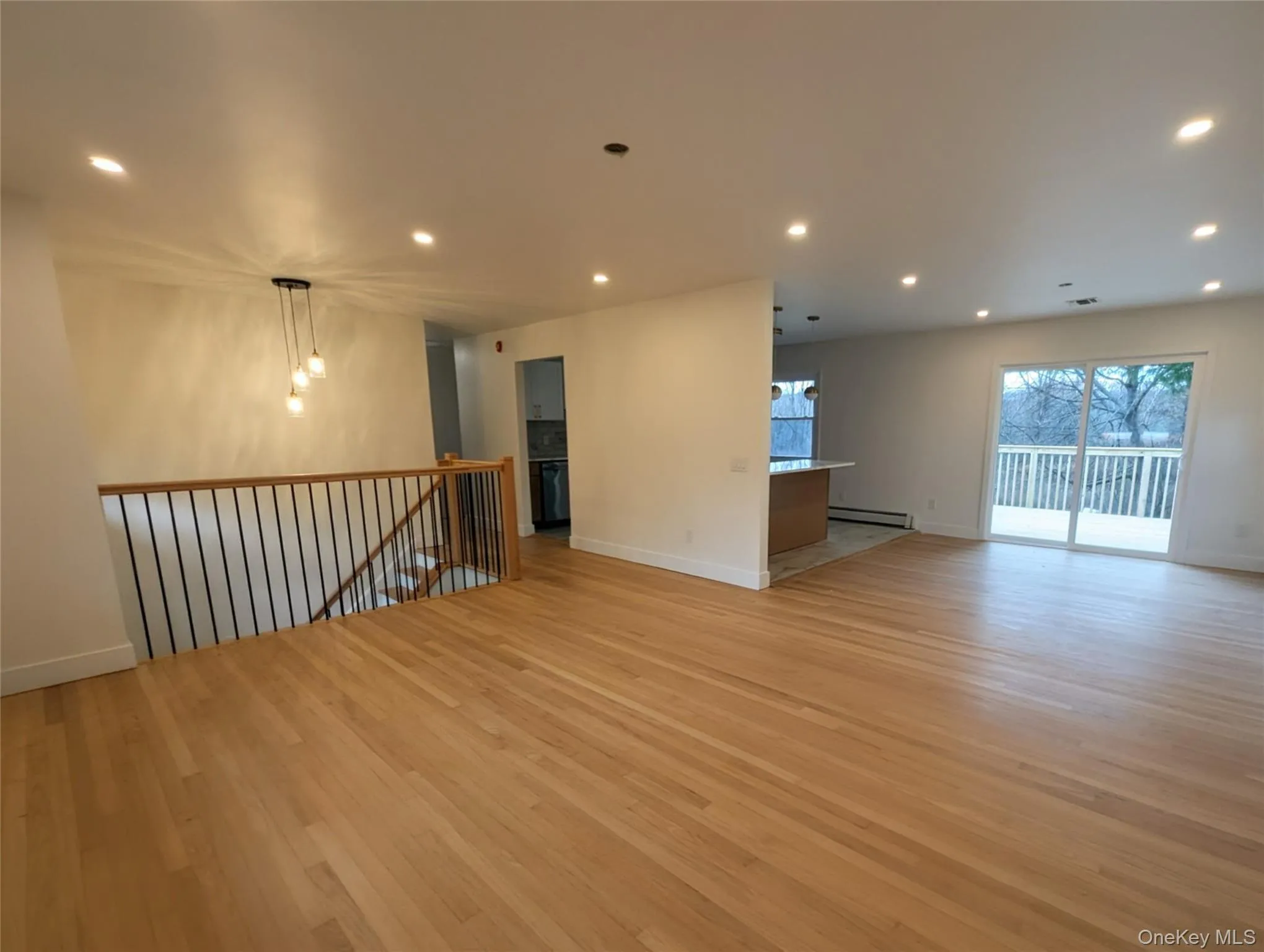 Spare room with recessed lighting, light wood finished floors, and baseboard heating Spare room with recessed lighting, light wood finished floors, and baseboard heating