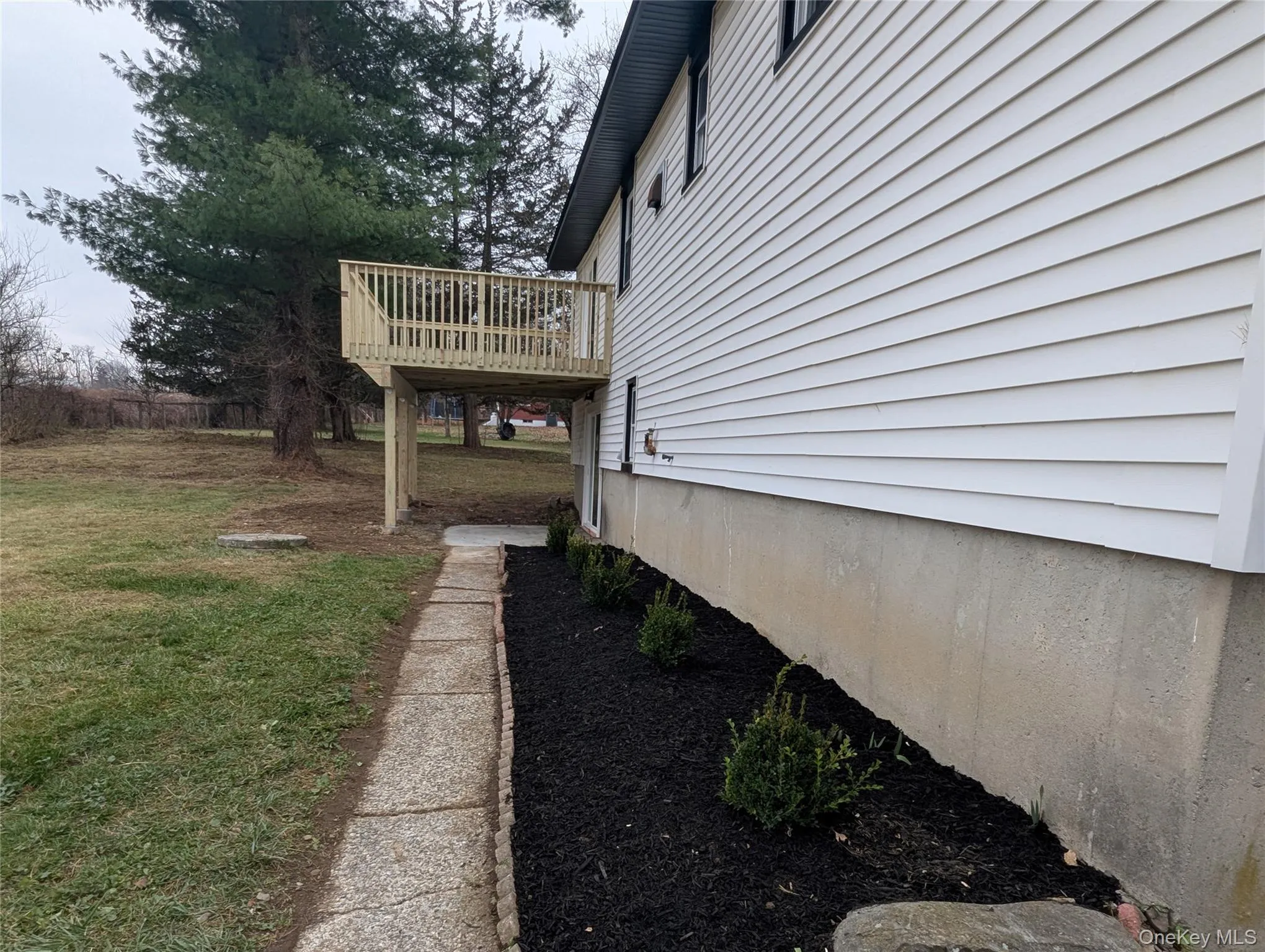 View of grassy yard featuring a deck View of grassy yard featuring a deck