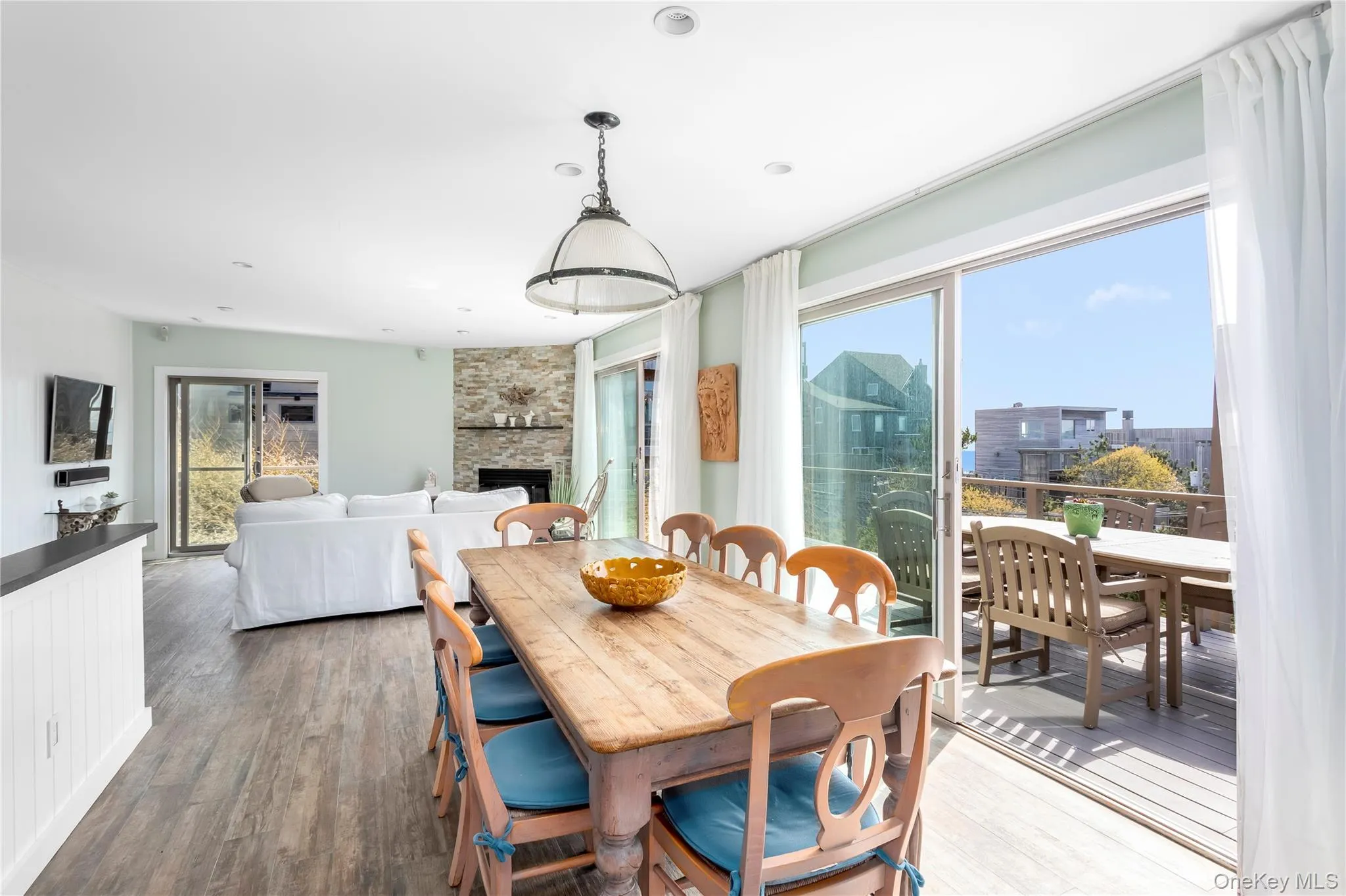 Dining space with a fireplace and wood finished floors Dining space with a fireplace and wood finished floors