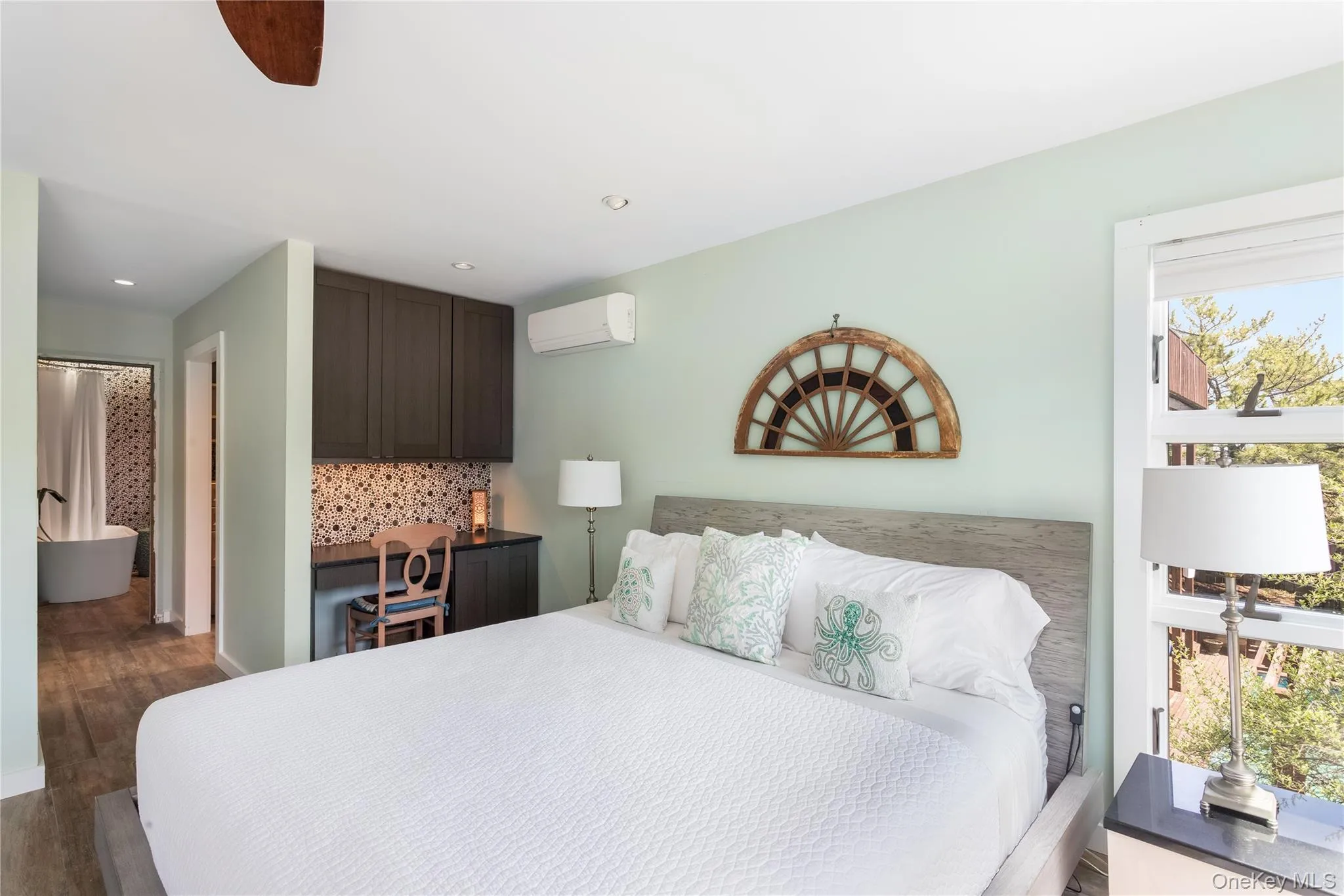 Bedroom featuring dark wood-style floors, recessed lighting, and a wall mounted air conditioner Bedroom featuring dark wood-style floors, recessed lighting, and a wall mounted air conditioner