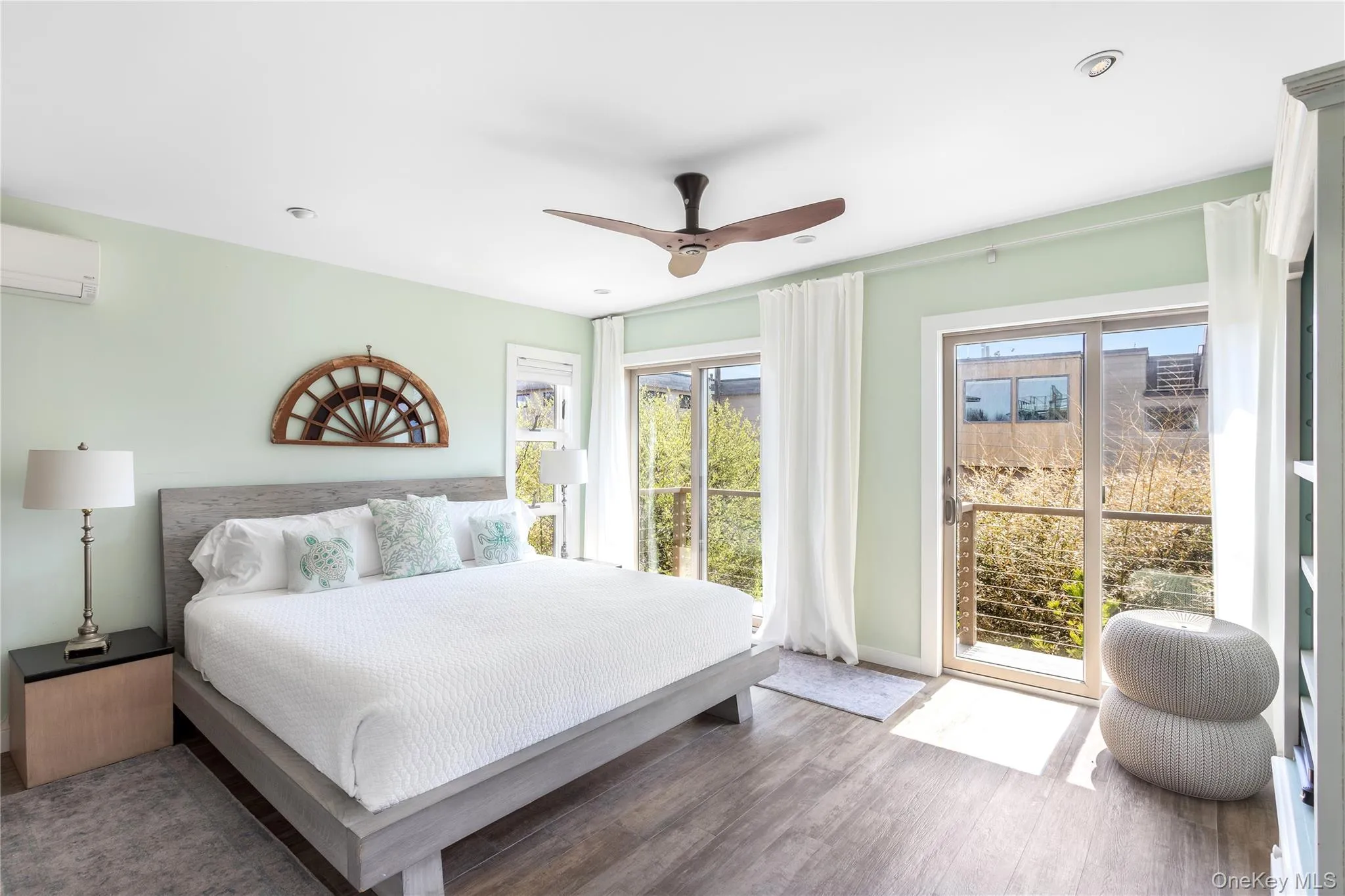Bedroom with wood finished floors, ceiling fan, a wall mounted air conditioner, and recessed lighting Bedroom with wood finished floors, ceiling fan, a wall mounted air conditioner, and recessed lighting