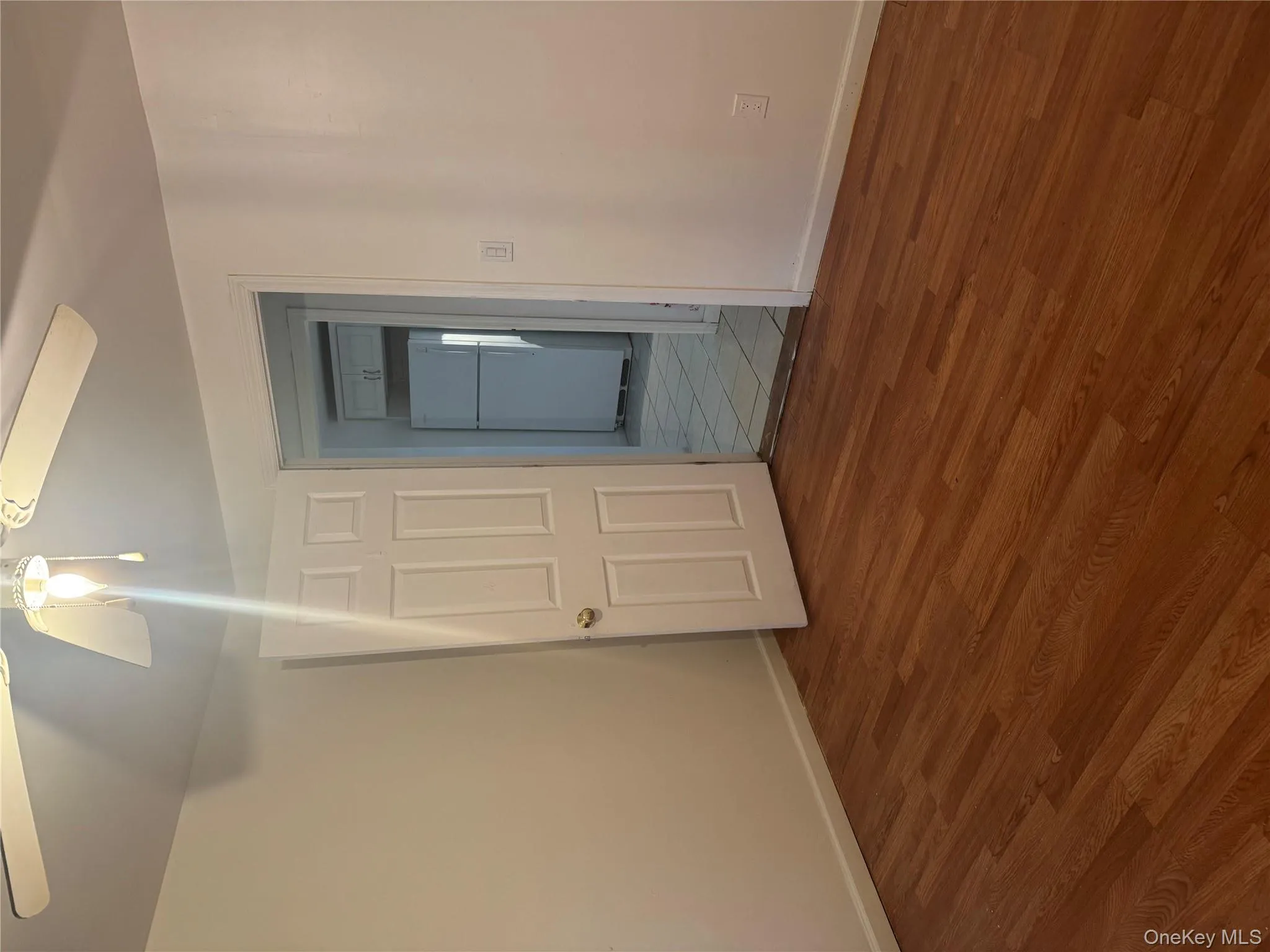 Unfurnished room featuring ceiling fan and wood finished floors Unfurnished room featuring ceiling fan and wood finished floors