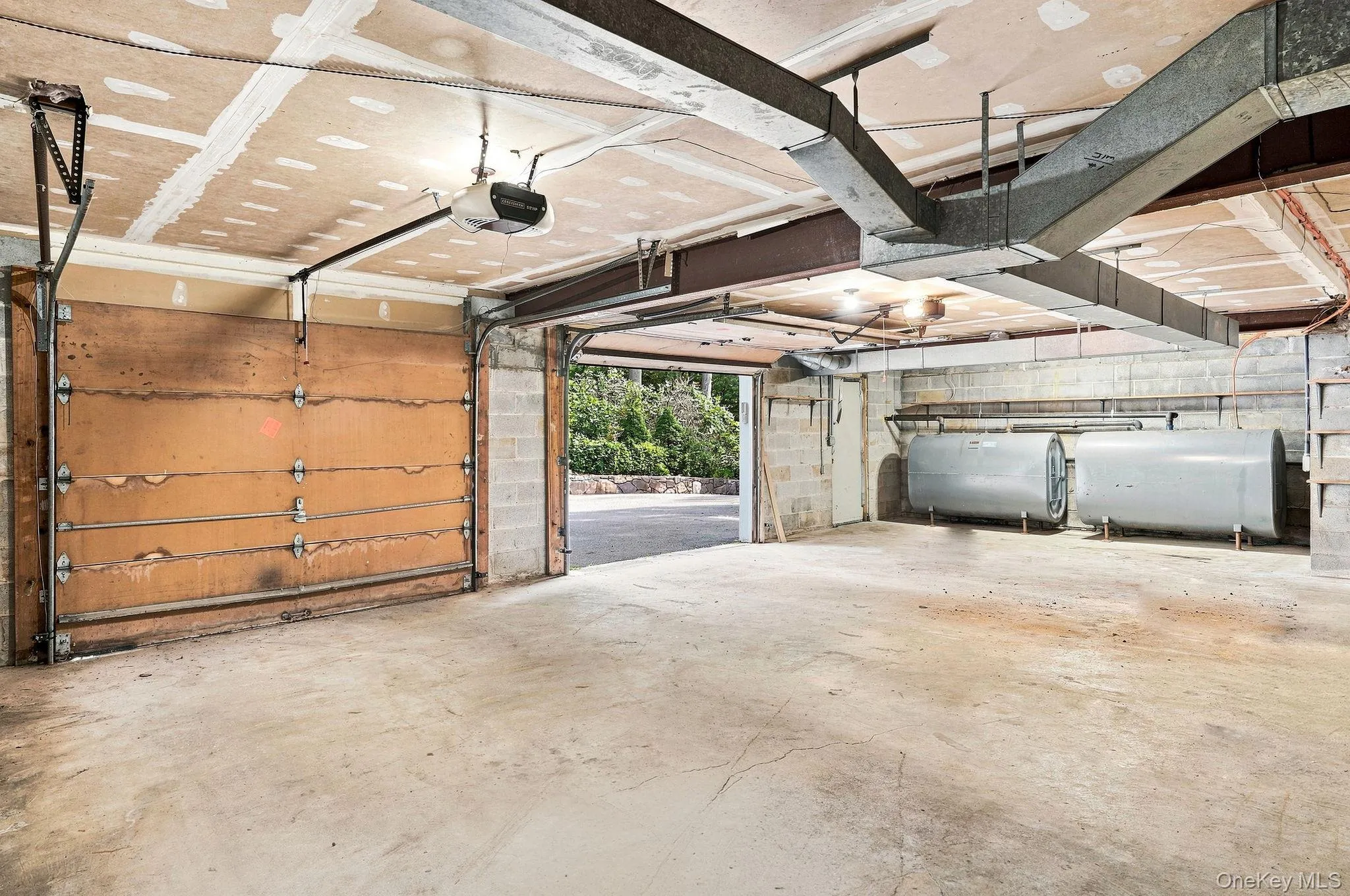 Concrete flooring in a multi-use space with exposed ductwork and structural beams Concrete flooring in a multi-use space with exposed ductwork and structural beams