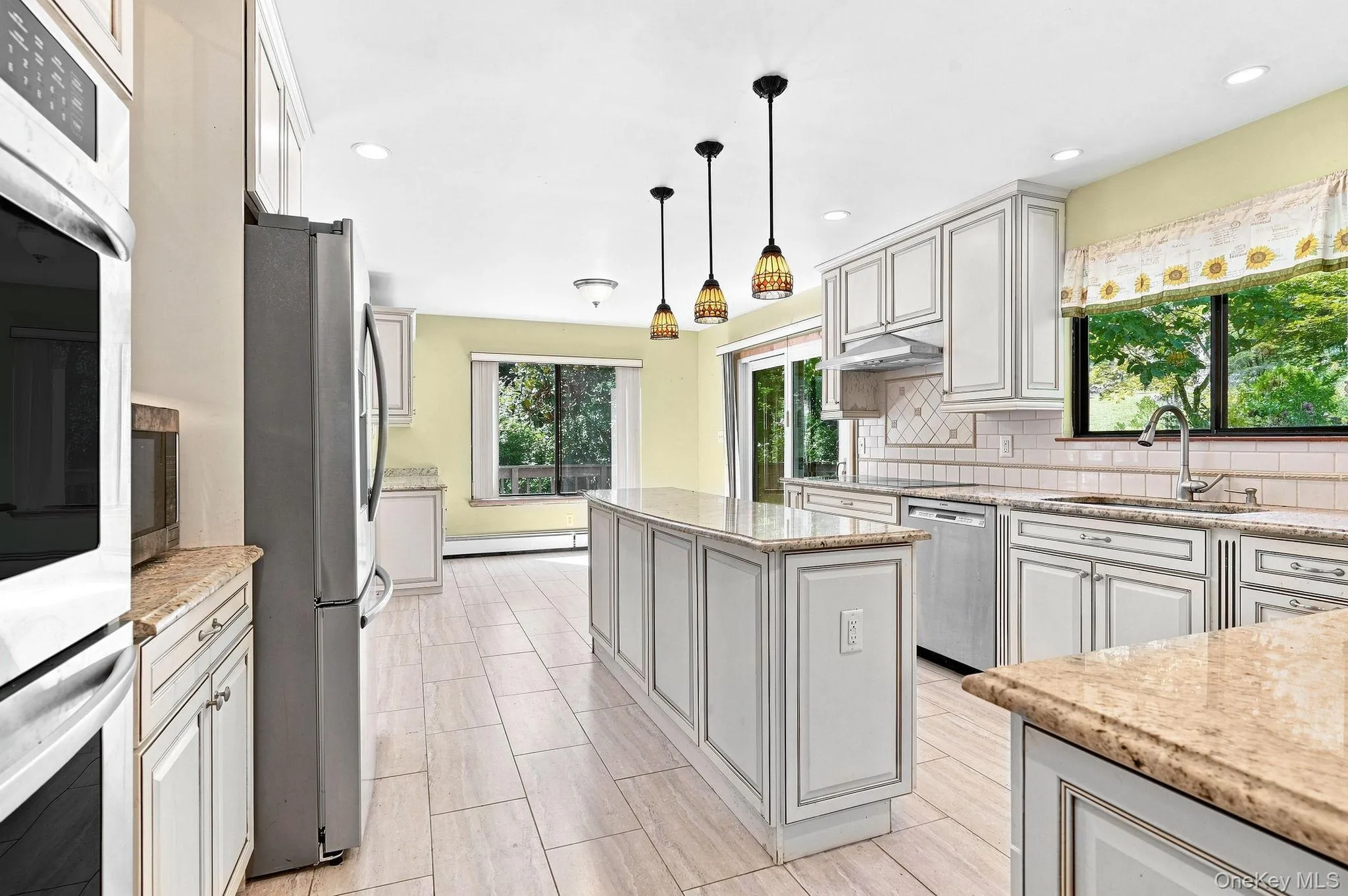 Open kitchen featuring a center island, recessed lighting, and pendant fixtures Open kitchen featuring a center island, recessed lighting, and pendant fixtures