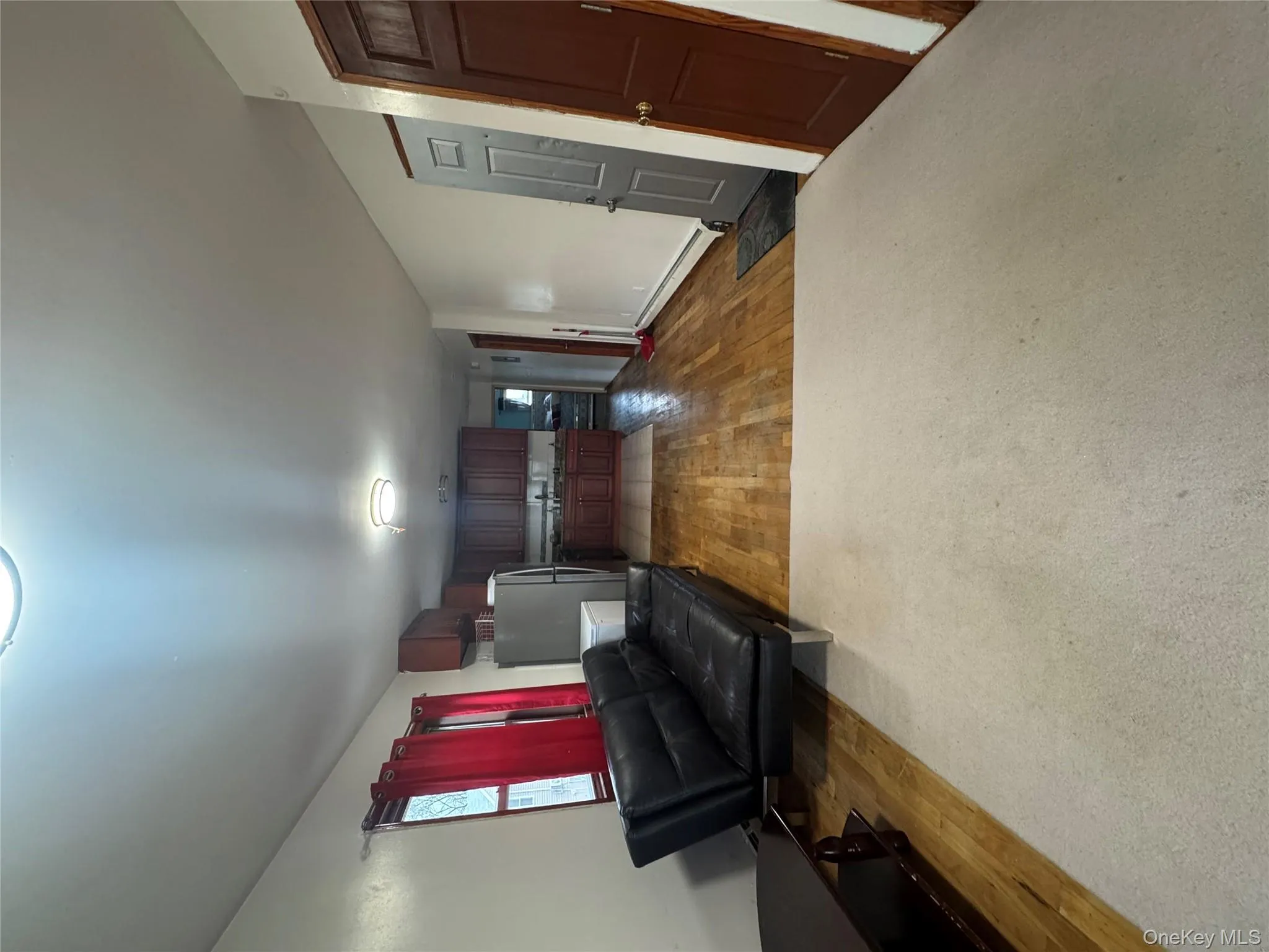 Living room featuring light wood-style flooring and baseboard heating Living room featuring light wood-style flooring and baseboard heating