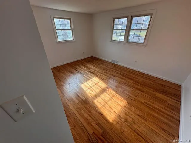 Empty room featuring light wood-type flooring and baseboards Empty room featuring light wood-type flooring and baseboards