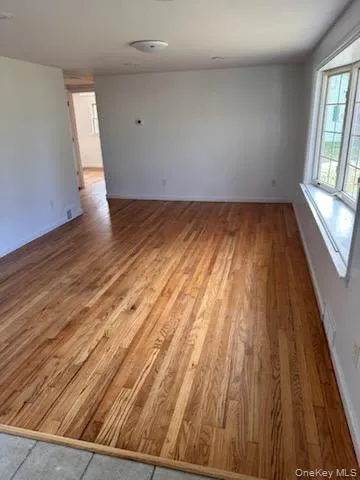 Unfurnished room featuring light wood finished floors and baseboards Unfurnished room featuring light wood finished floors and baseboards
