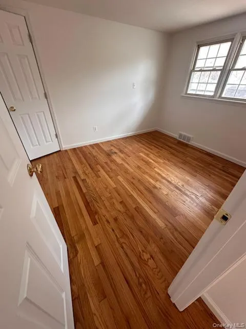 Unfurnished bedroom featuring light wood-style floors and baseboards Unfurnished bedroom featuring light wood-style floors and baseboards