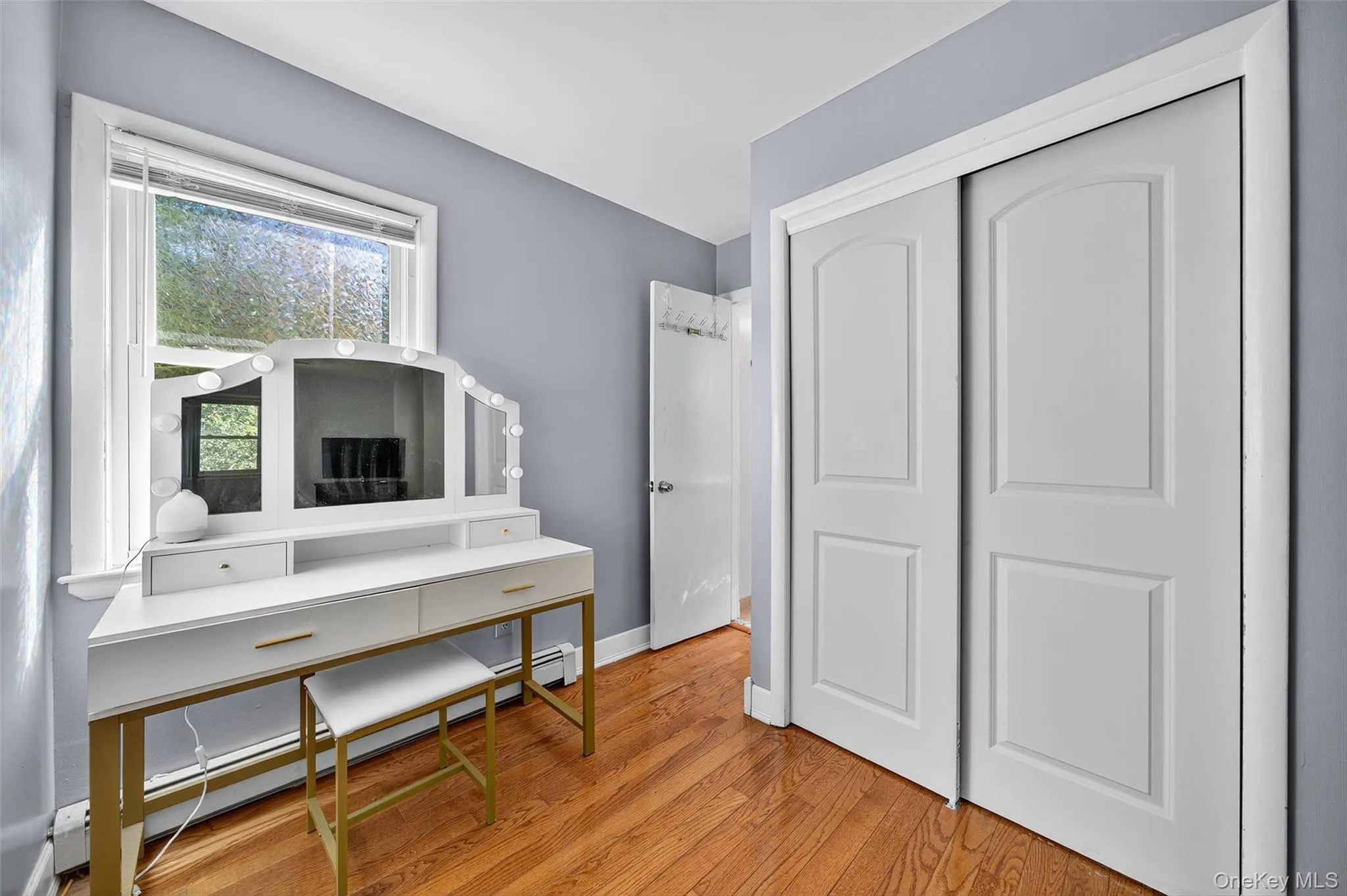 Office space featuring a baseboard radiator and light wood-type flooring Office space featuring a baseboard radiator and light wood-type flooring