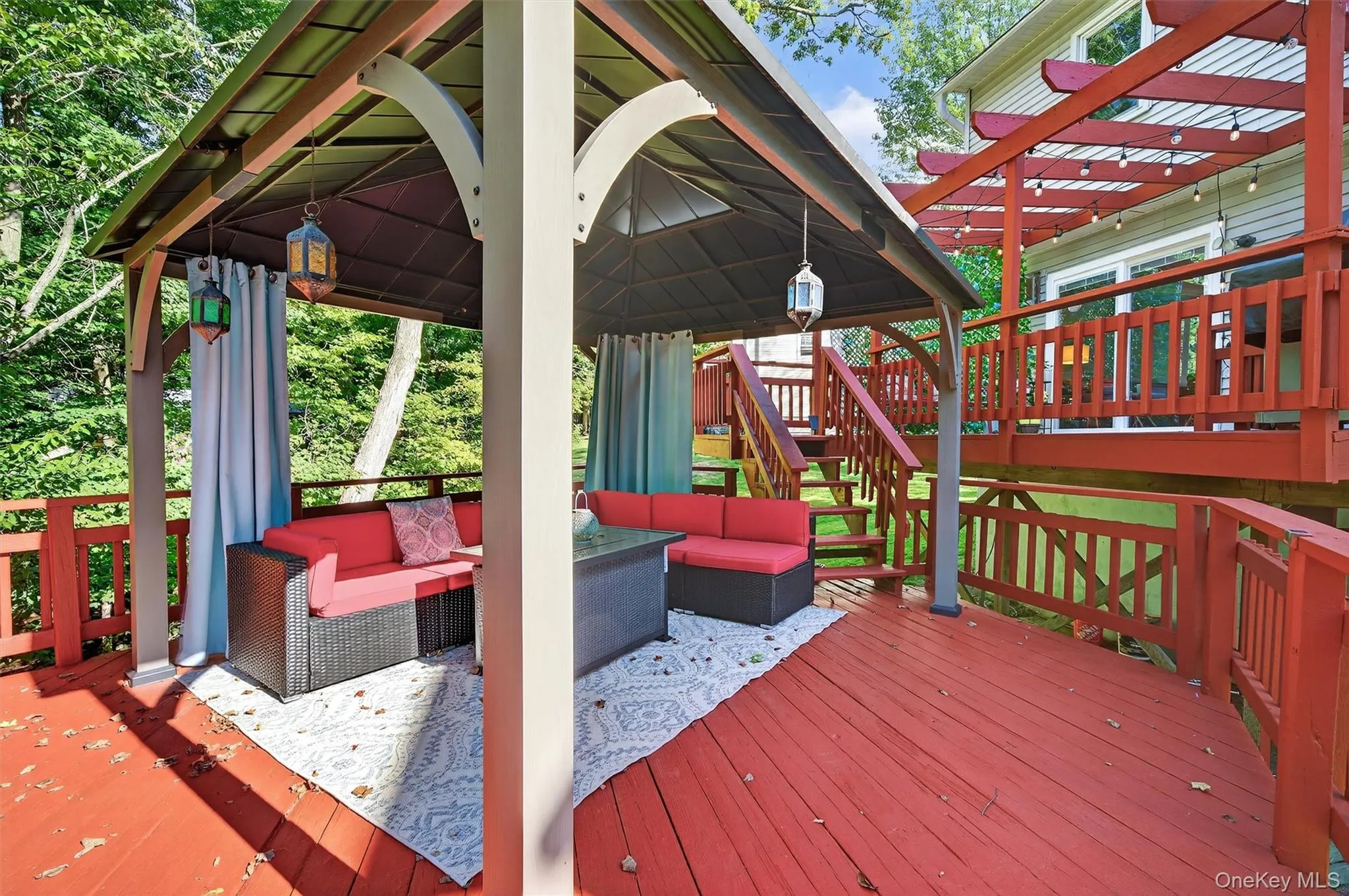 Wooden terrace with a gazebo and outdoor lounge area Wooden terrace with a gazebo and outdoor lounge area