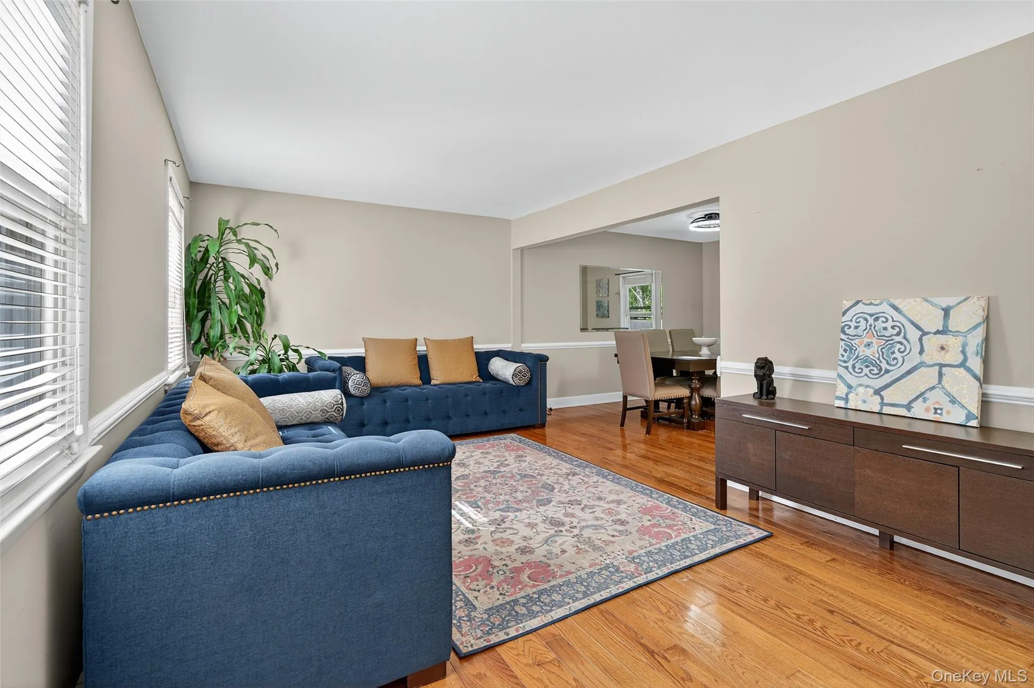 Living room with light wood-style flooring and baseboards Living room with light wood-style flooring and baseboards